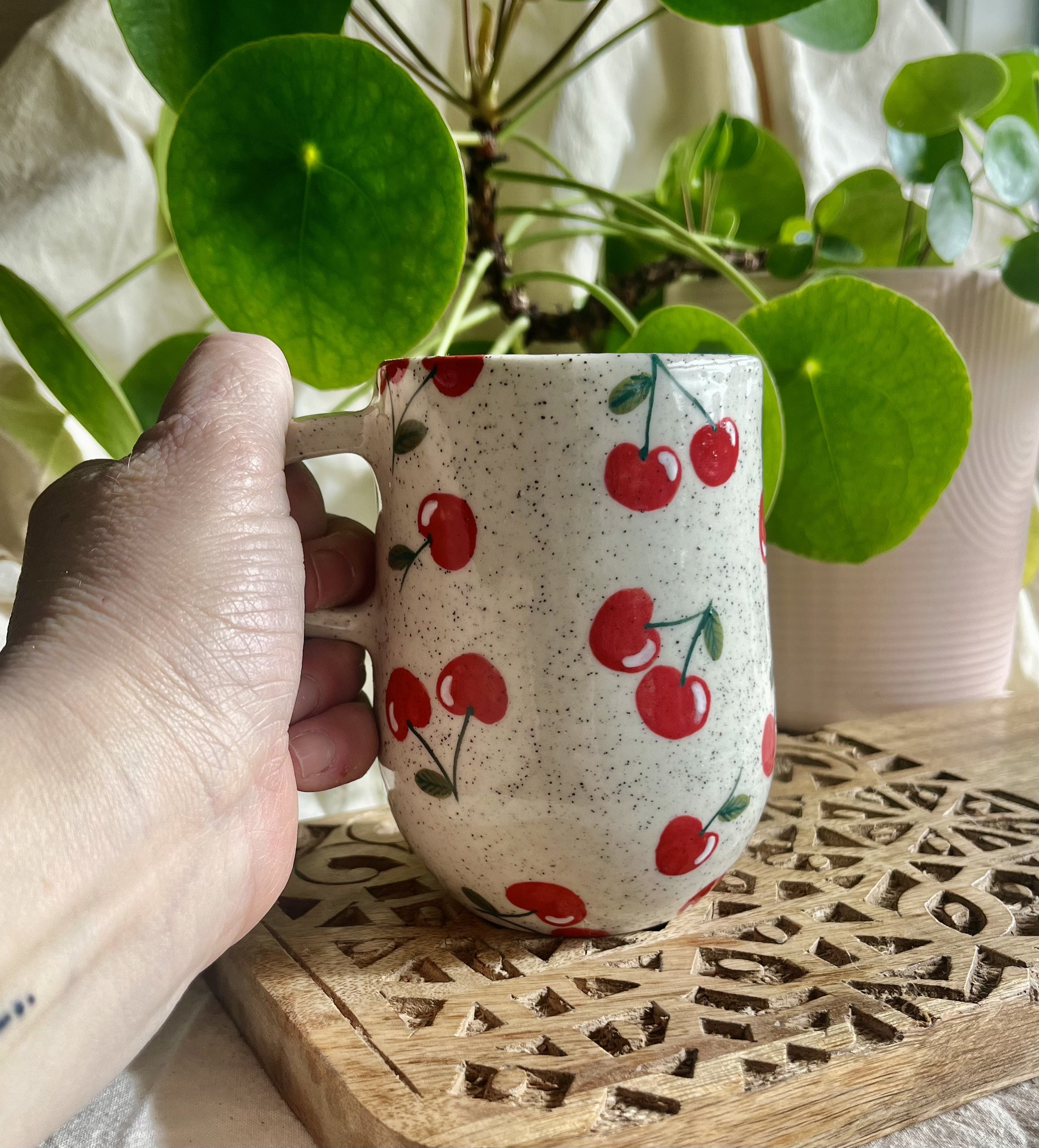 Cherry mug 2 in hand view.jpeg