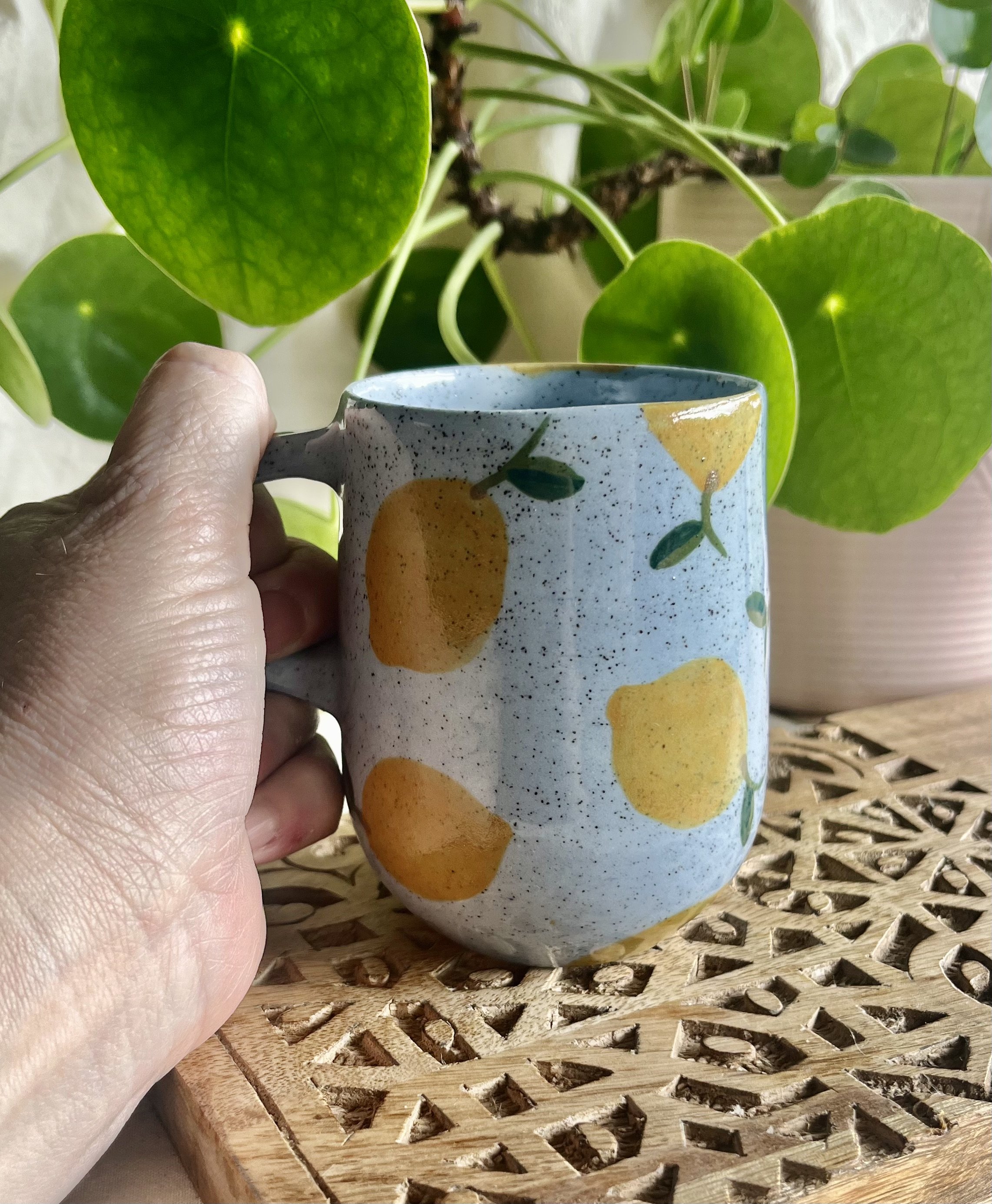 Blue lemon mug 1 in hand view.jpeg