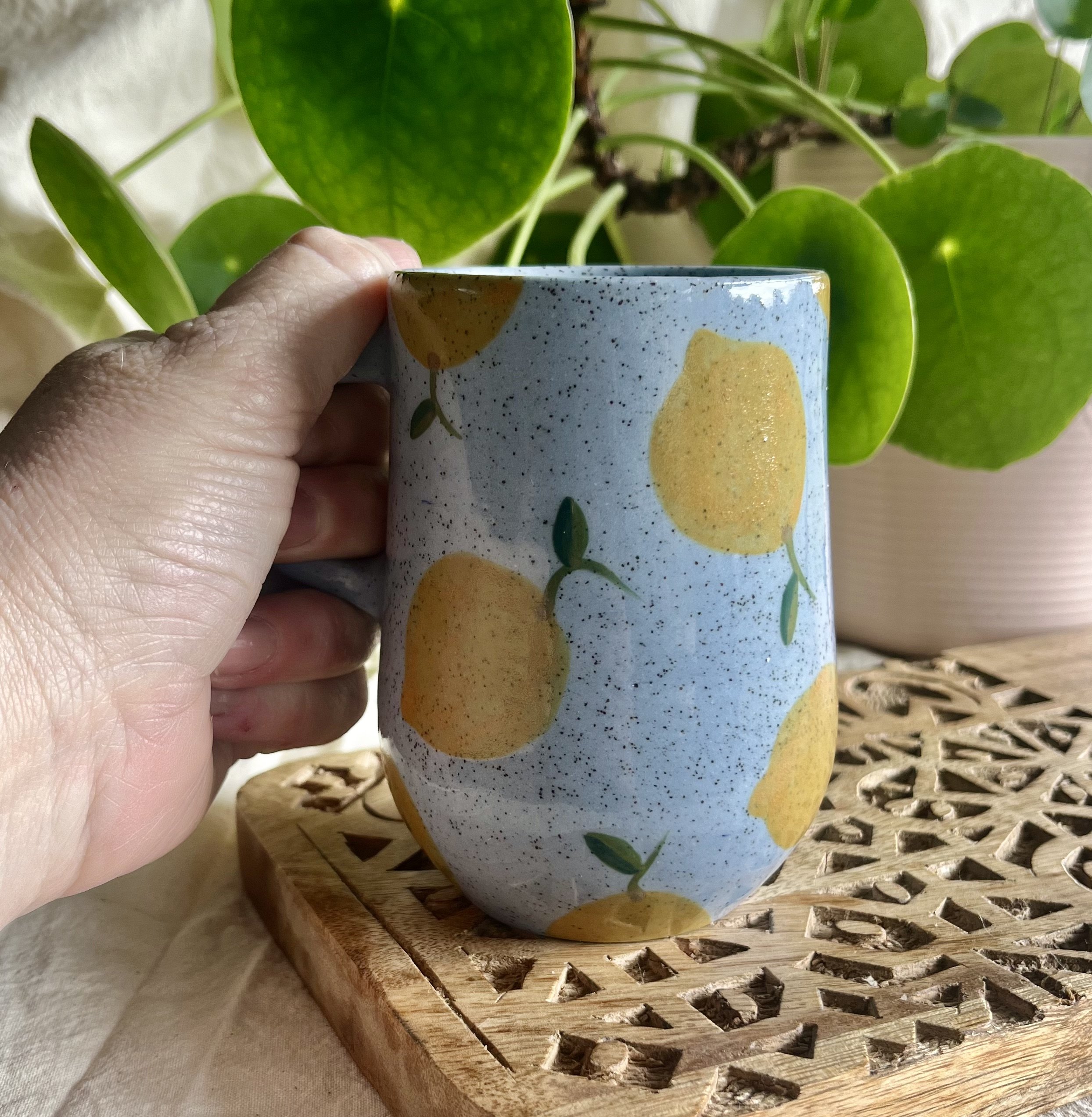 Blue lemon mug 2 in hand view.jpeg