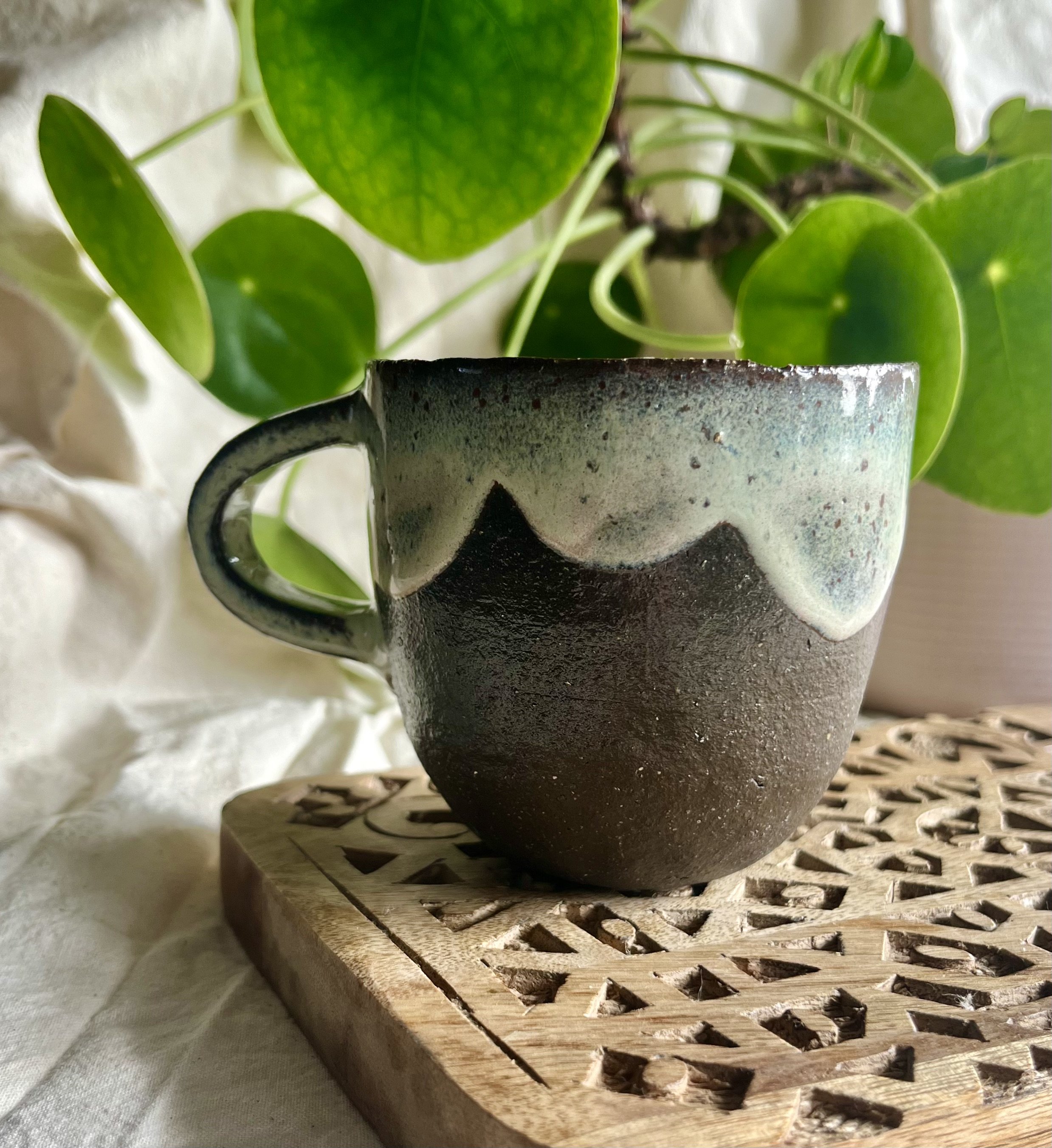 Cream on dark matter scalloped mug 1 front view.jpeg