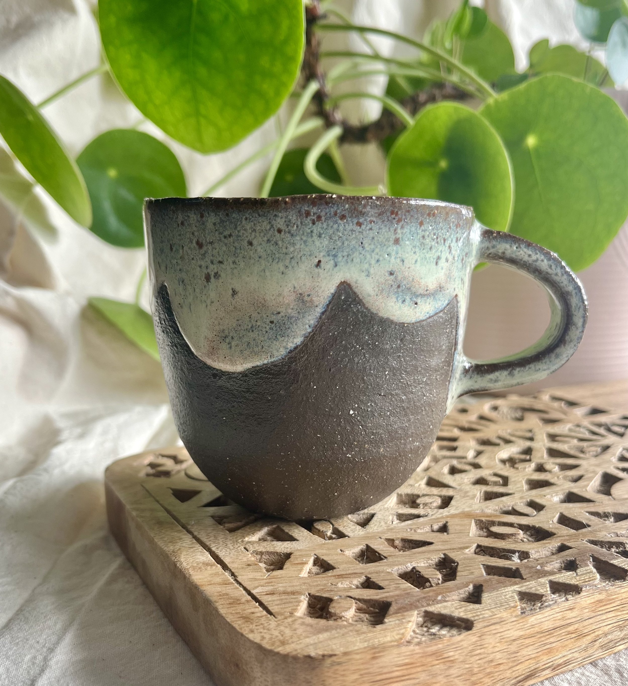 Cream on dark matter scalloped mug 1 back view.jpeg