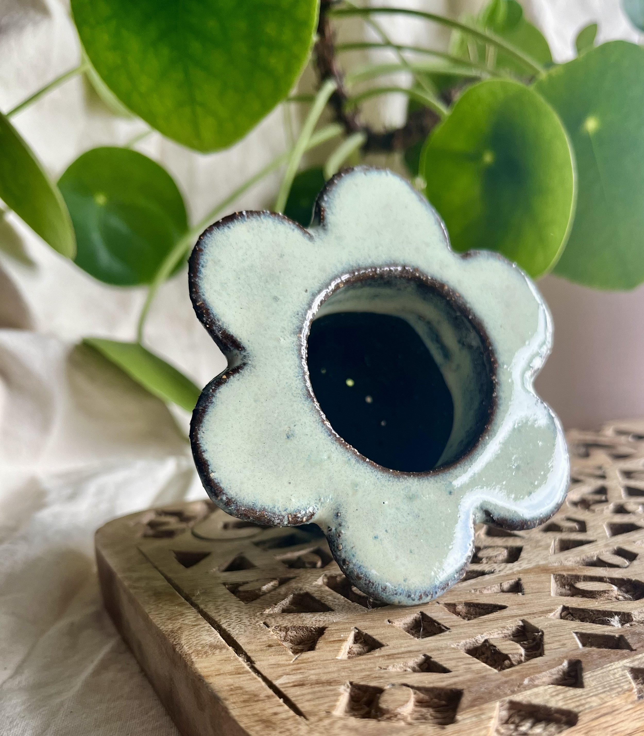 Cream on dark matter flower tea strainer front view.jpeg