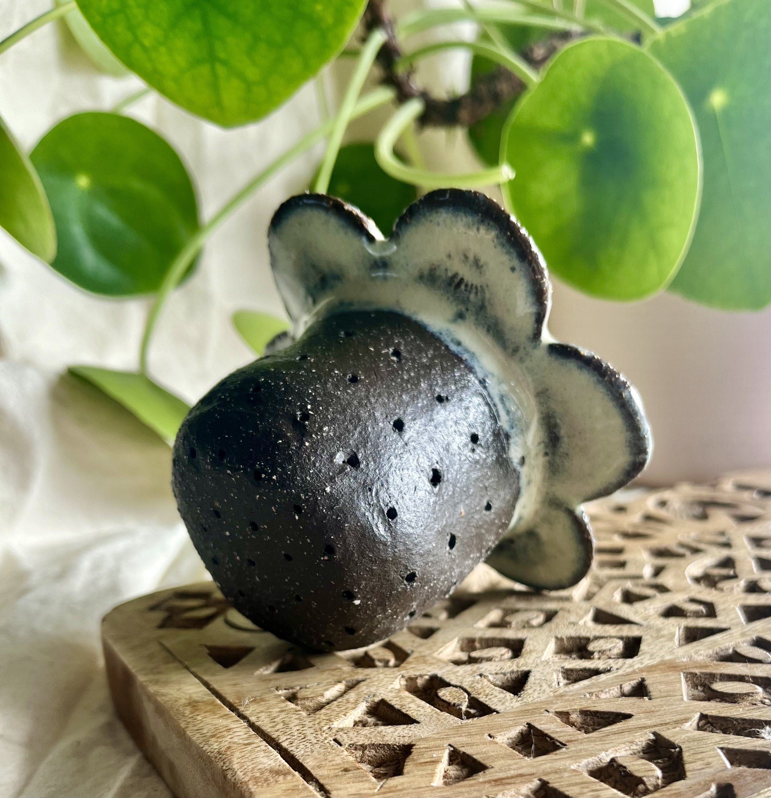 Cream on dark matter flower tea strainer bottom view.jpeg