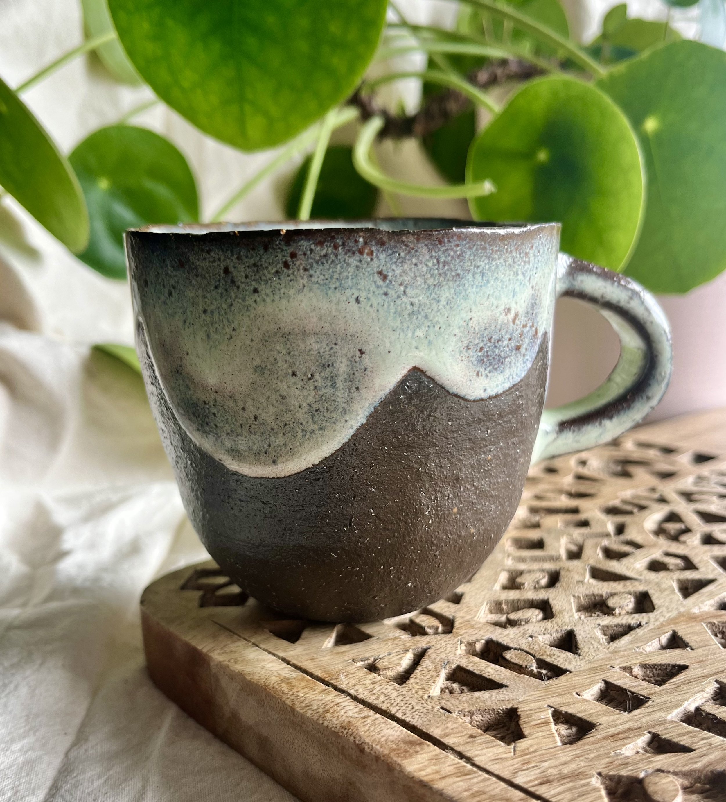 Cream on dark matter scalloped mug 2 front view.jpeg