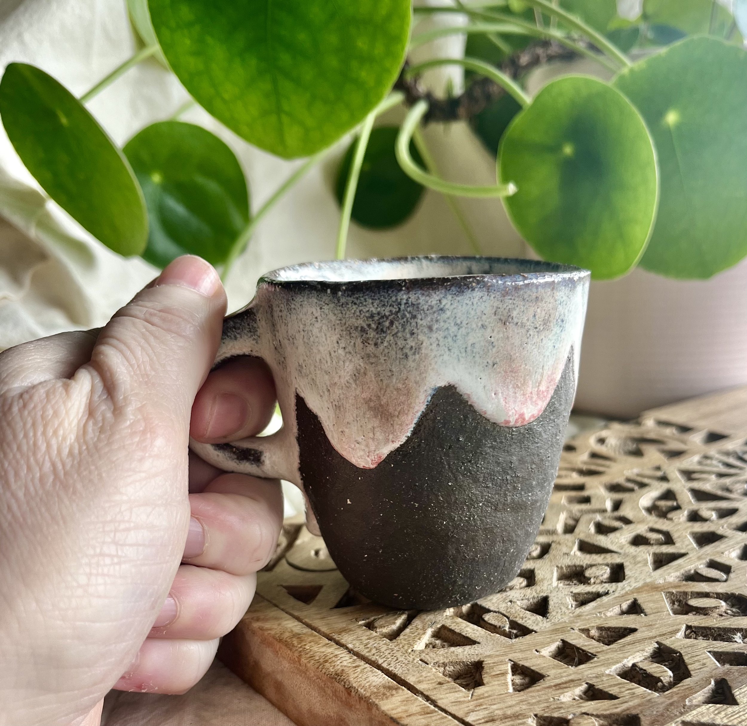 Cream espresso cup in hand view.jpeg