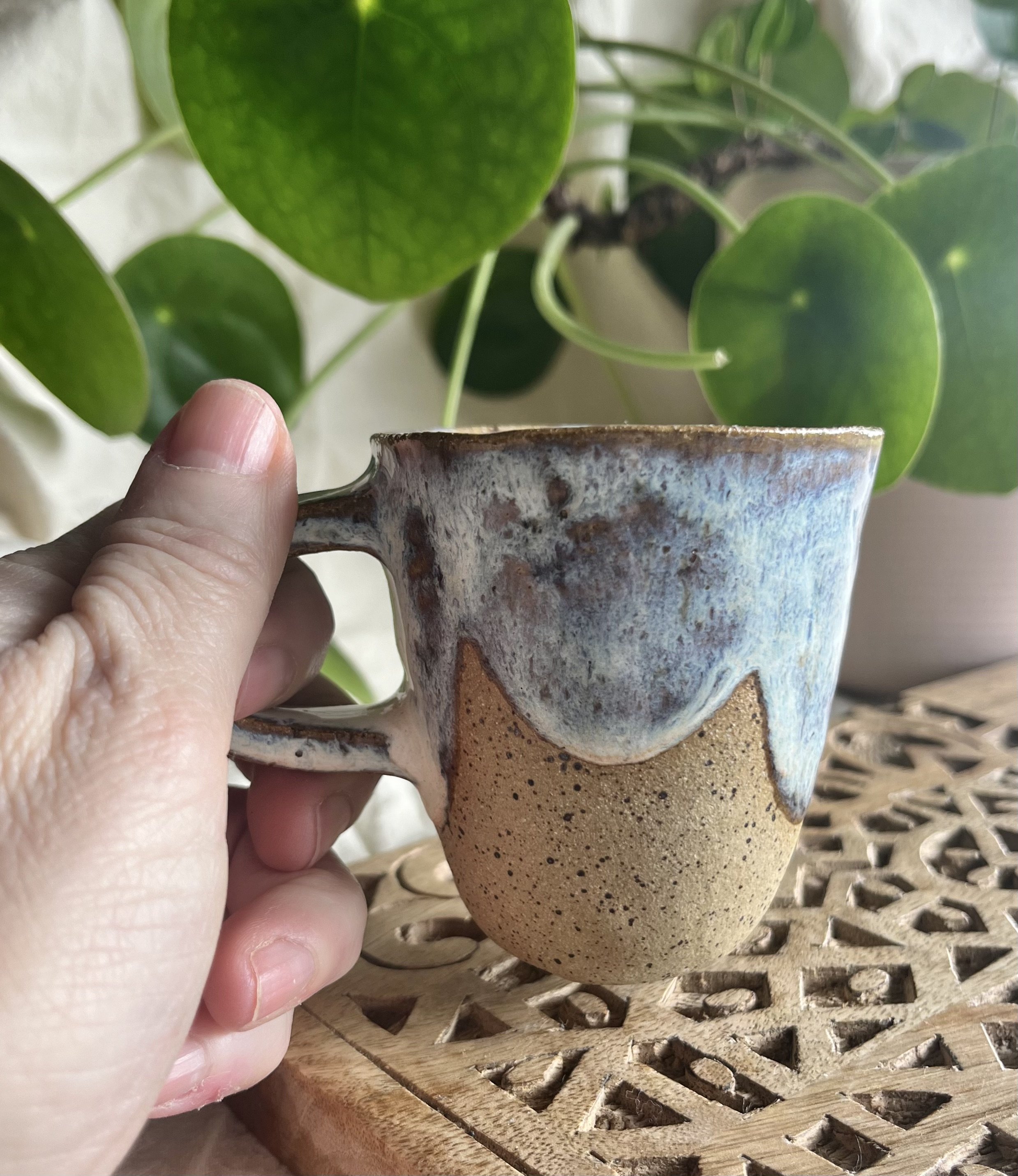 blue and cream espresso cup in hand view.jpeg