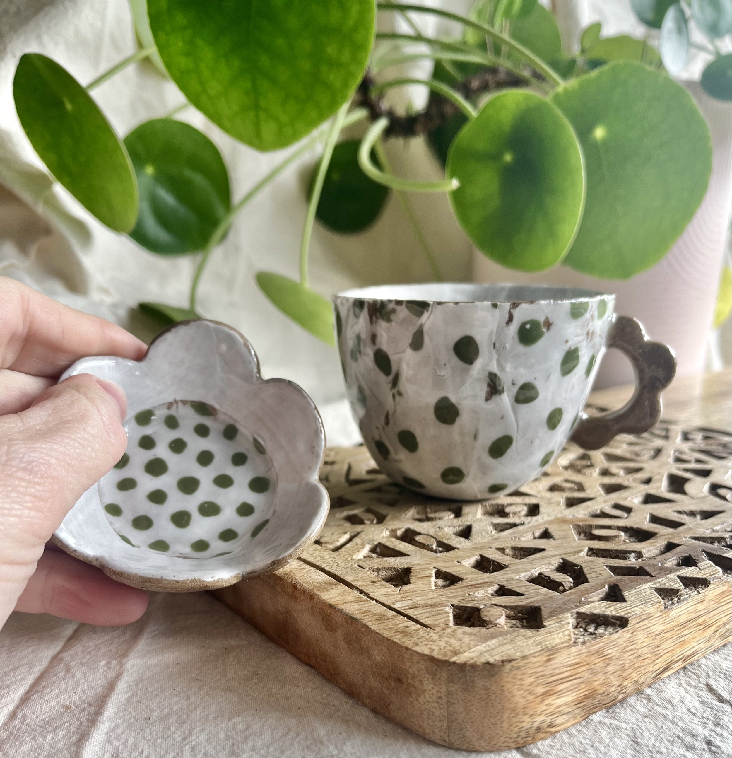 Green spotty espresso cup and saucer in hand view 2.jpeg