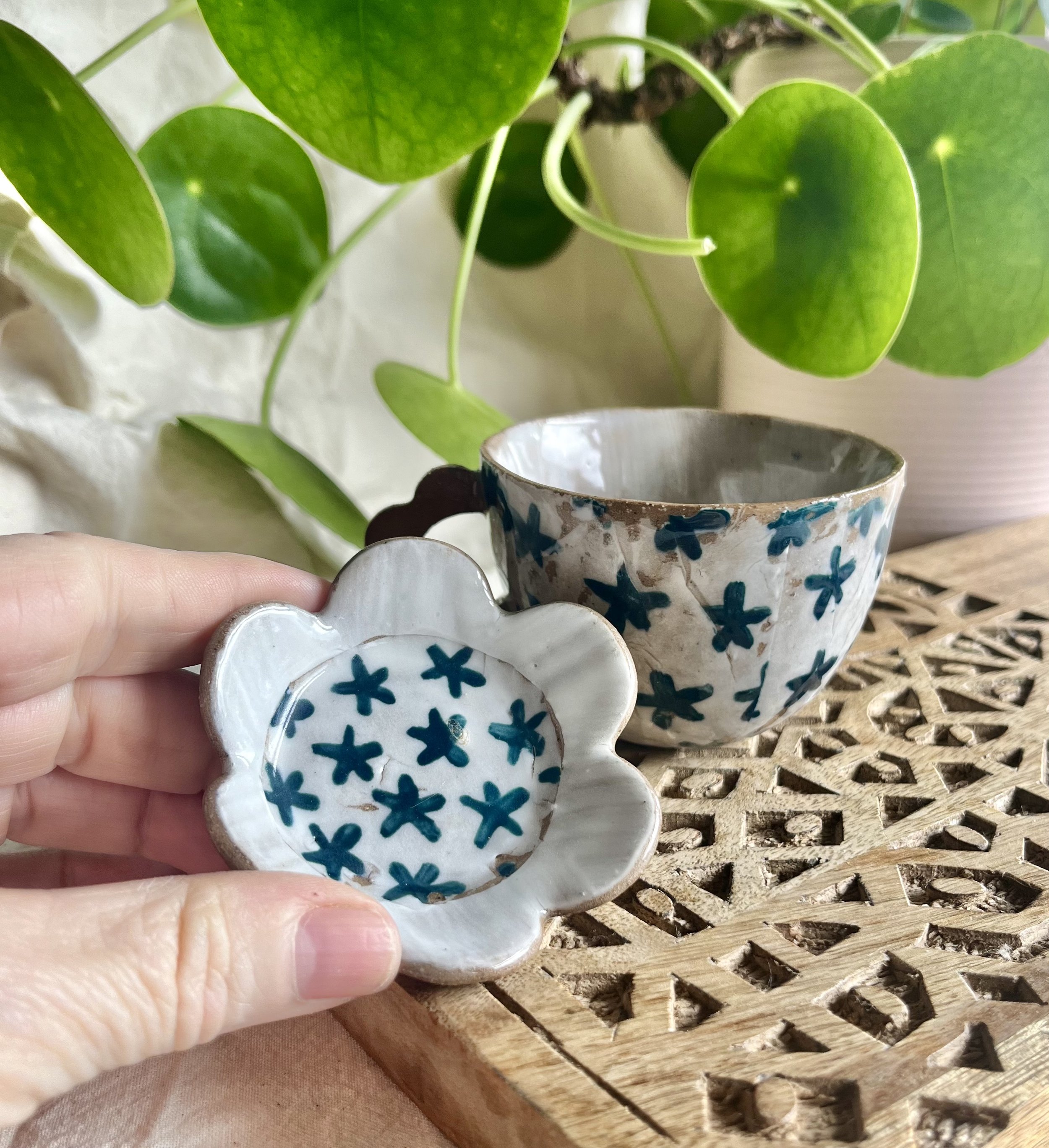 teal flower espresso cup and saucer in hand 2.jpeg