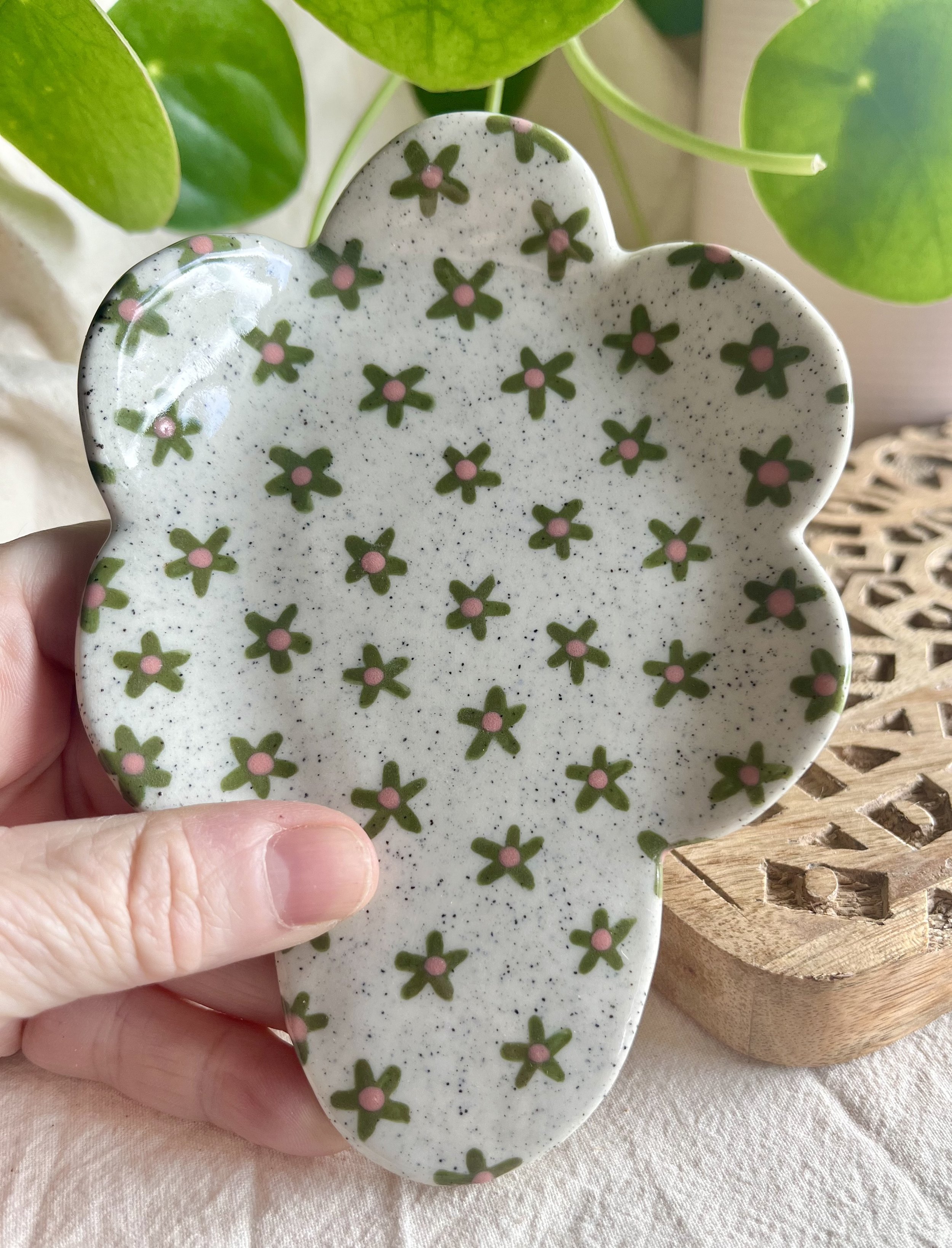 Green flower spoon rest in hand view.jpeg