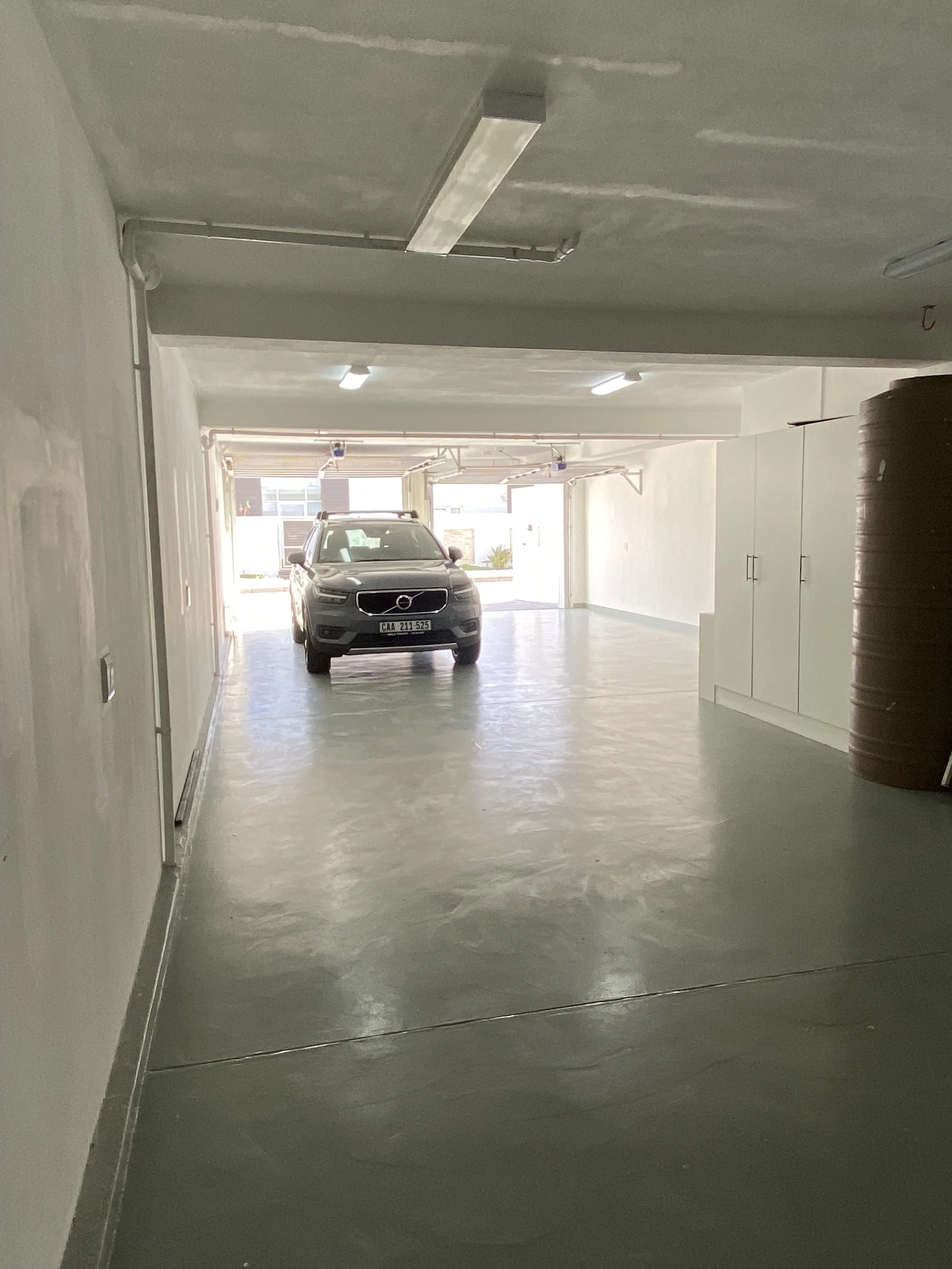 An indoor parking garage with space for 4 cars and storage