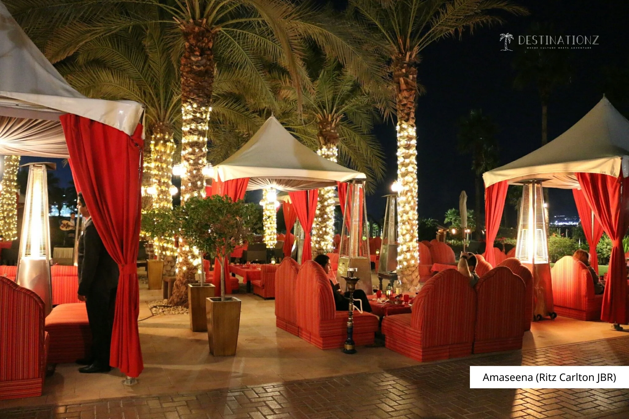 Outdoor Bedouin-style dining at Amaseena, Ritz-Carlton JBR 2026: traditional Arabian buffet, live music, and sea views in Dubai.