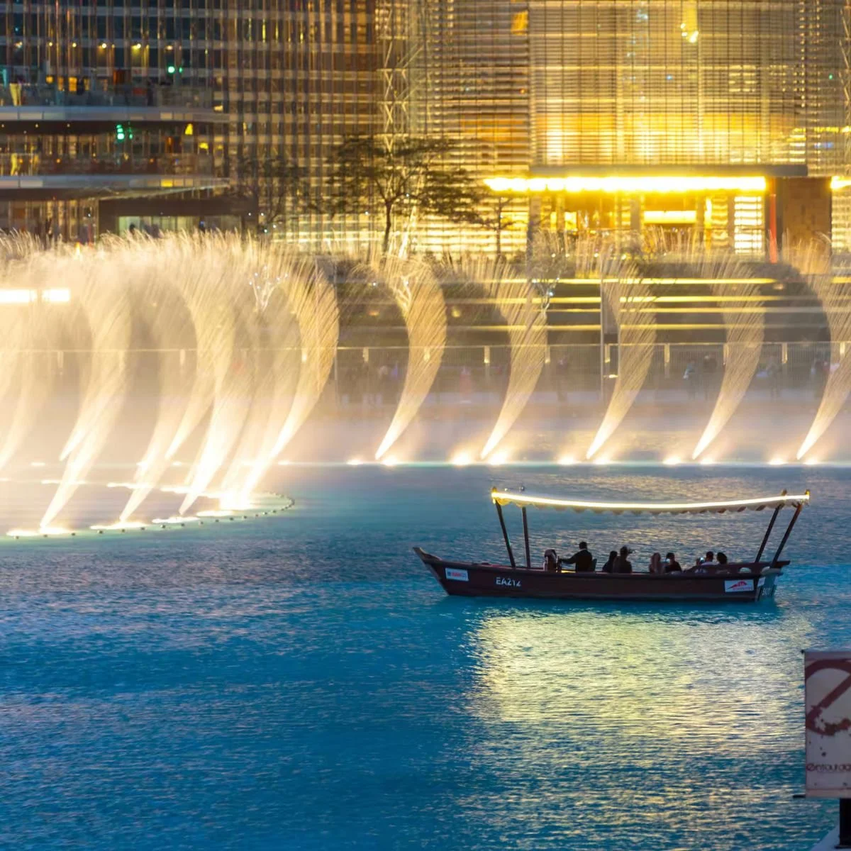 The iconic Dubai Fountain show at the base of Burj Khalifa featuring synchronized water lights and music in Downtown Dubai.