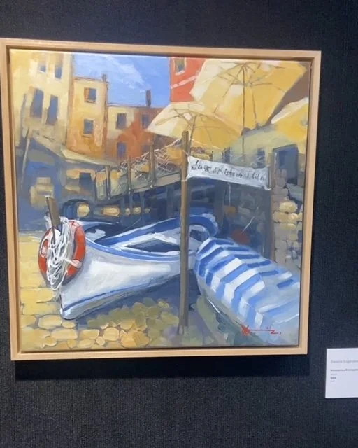 Painting of a dock with a boat, umbrella, and buildings in the background, using vibrant colors and brushstrokes.