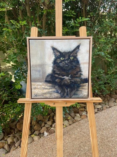 Ragdoll cat painting on an easel