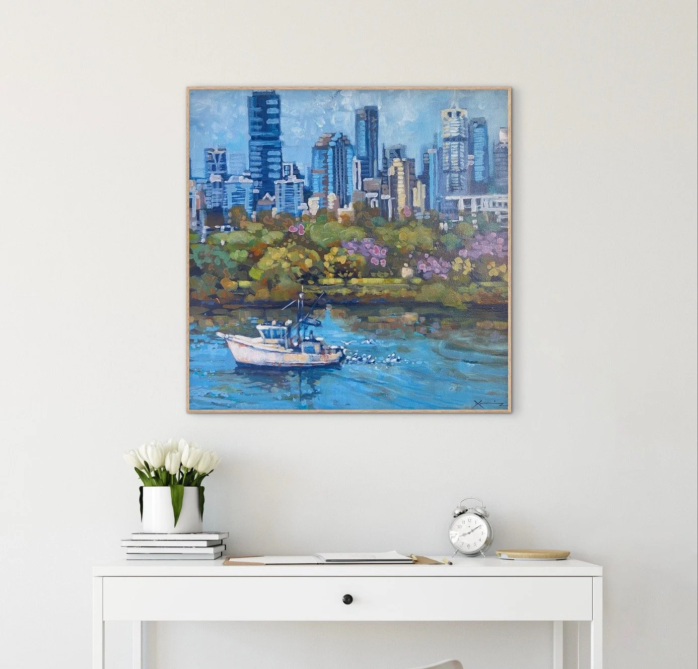 Painting on a wall of a boat on the river in front of a cityscape