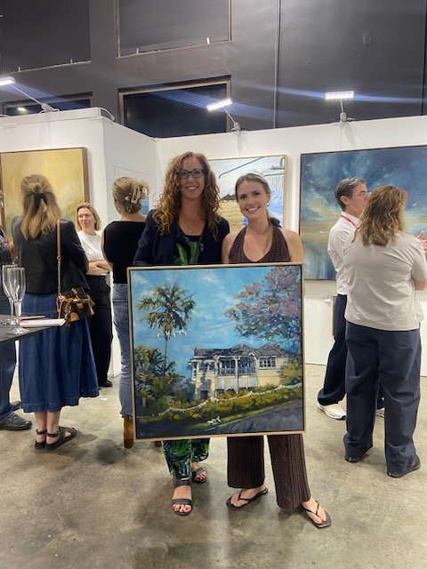 Displaying one of the many paintings sold at The Affordable Art Fair in Brisbane.  This painting is of an afternoon sun-lit Queenslander house in Hawthorne with a Jacaranda and Travellers Palm.