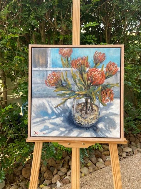 Orange protea painting on easel. jpg