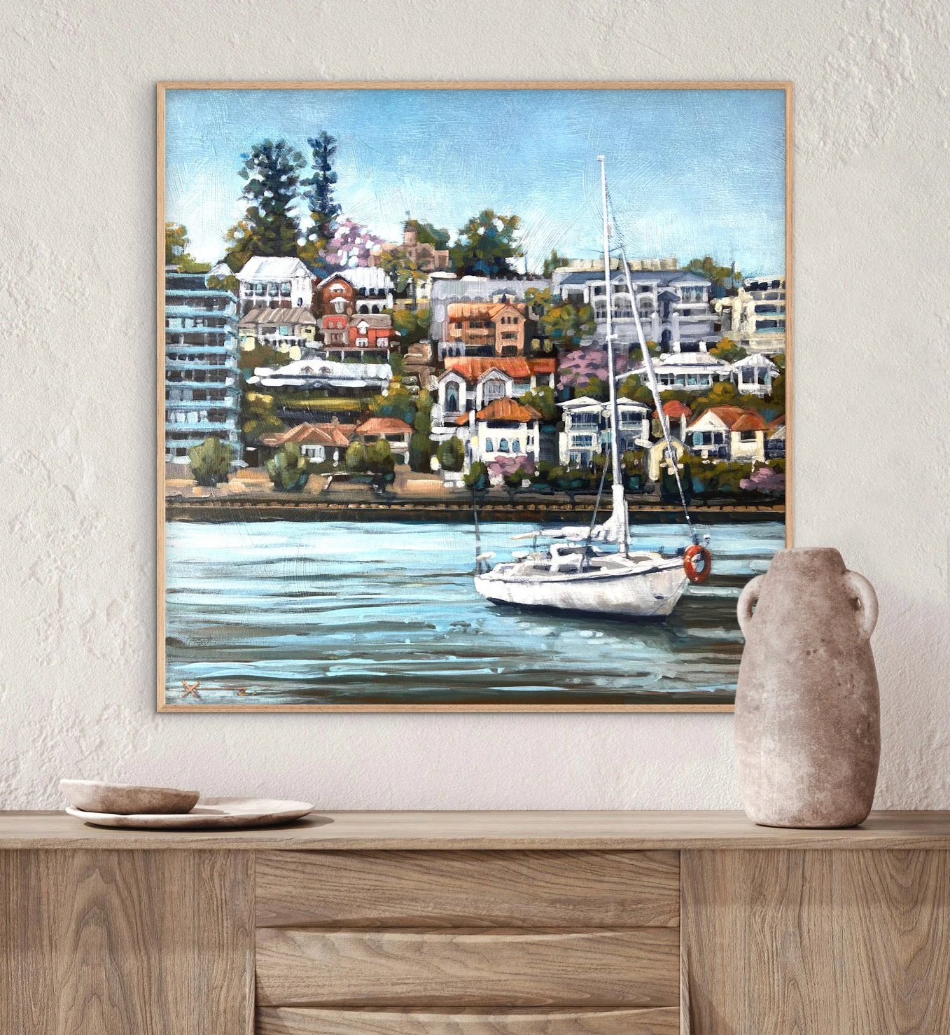 Painting of a yacht in front of colourful houses in Hamilton