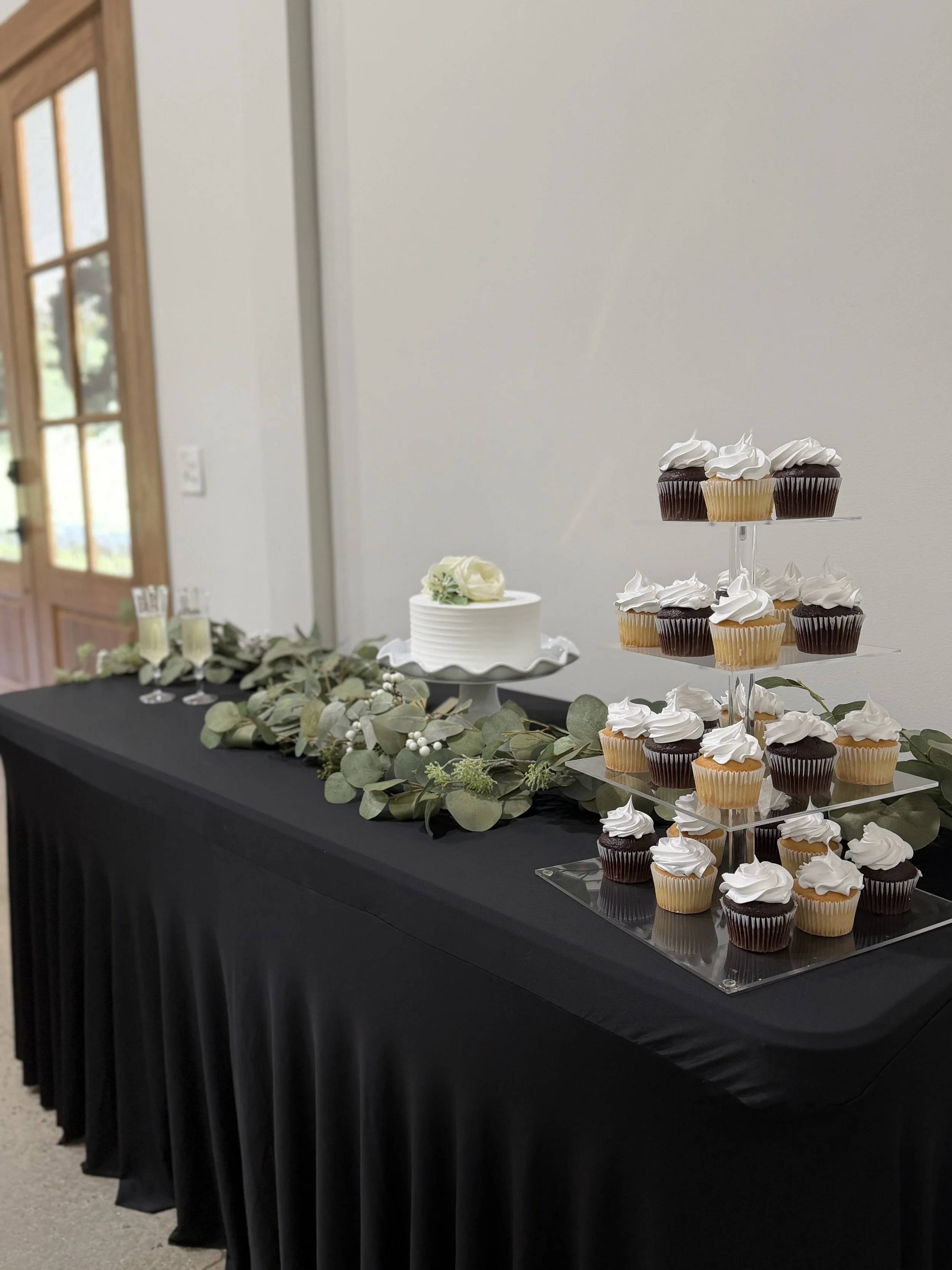 Cake, cupcakes and champagne display table at Sawyers Cove Farm
