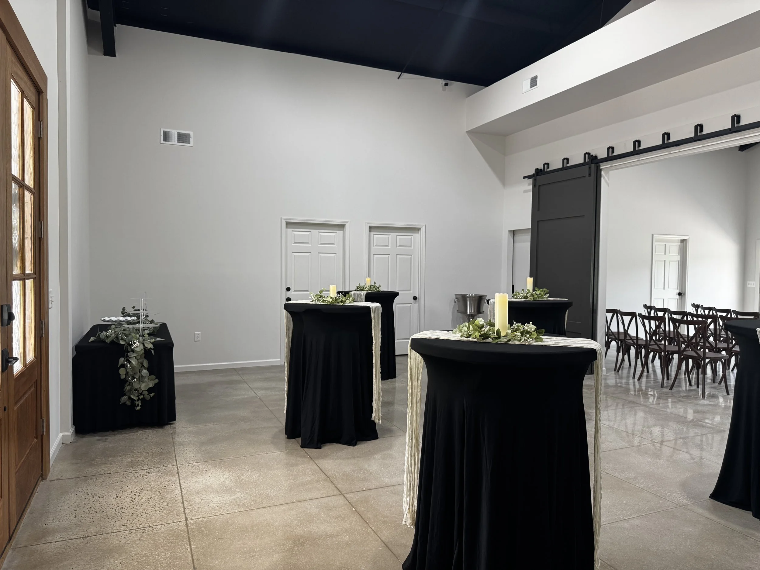 Reception space featuring wedding cake, cocktail tables, and décor included in the all-inclusive wedding package at Sawyers Cove Farm.