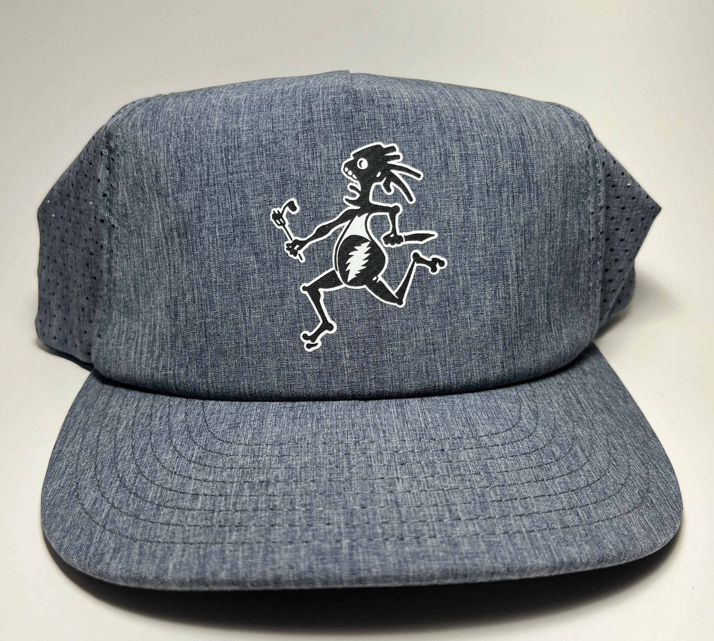 Gray cap with a black and white cartoon running flea holding a tiny hammer and a small dagger.