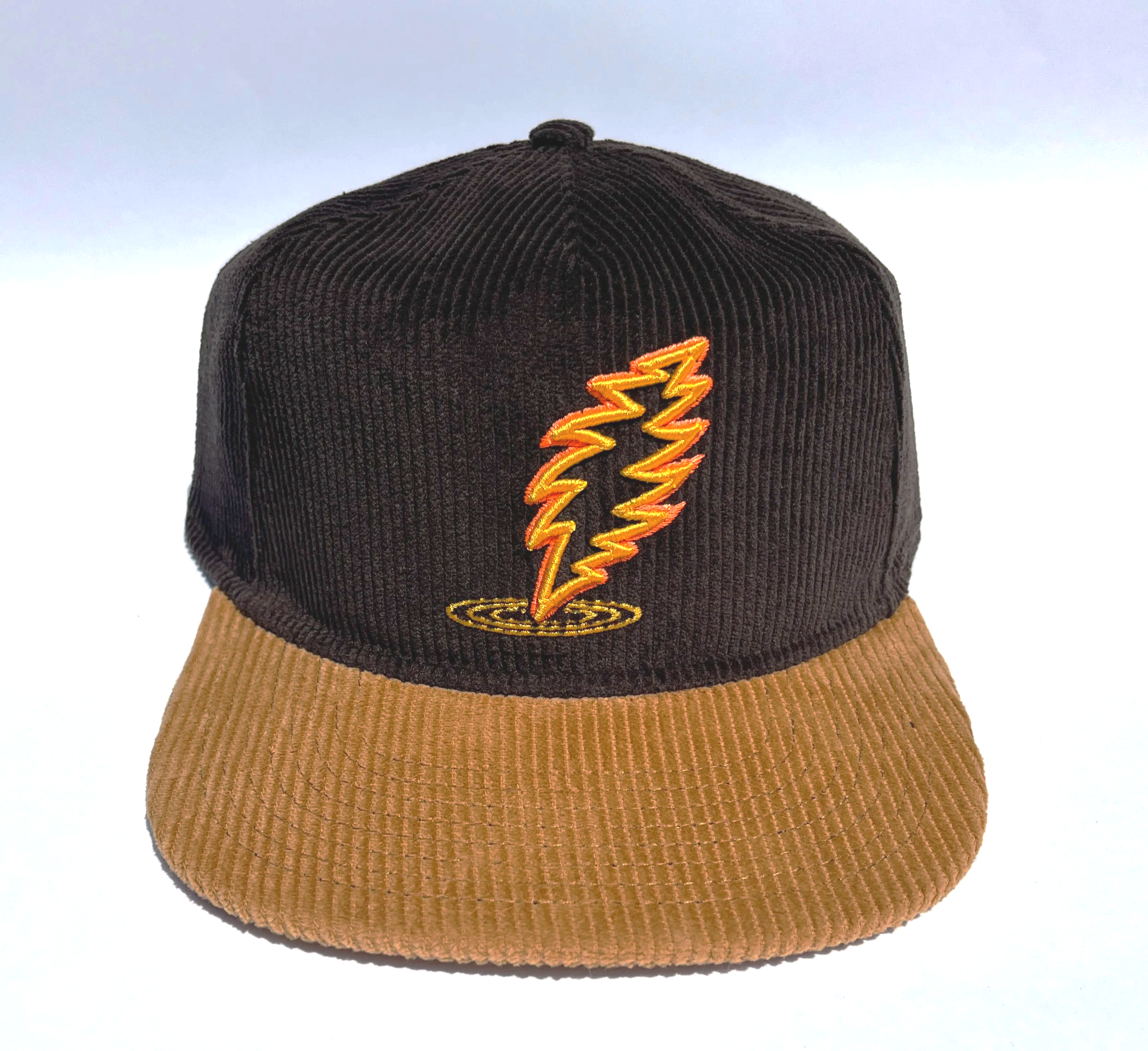 Espresso Brown corduroy baseball cap with a bronze brim, featuring a Dancin' bolt embroidered in yellow and orange highlight.