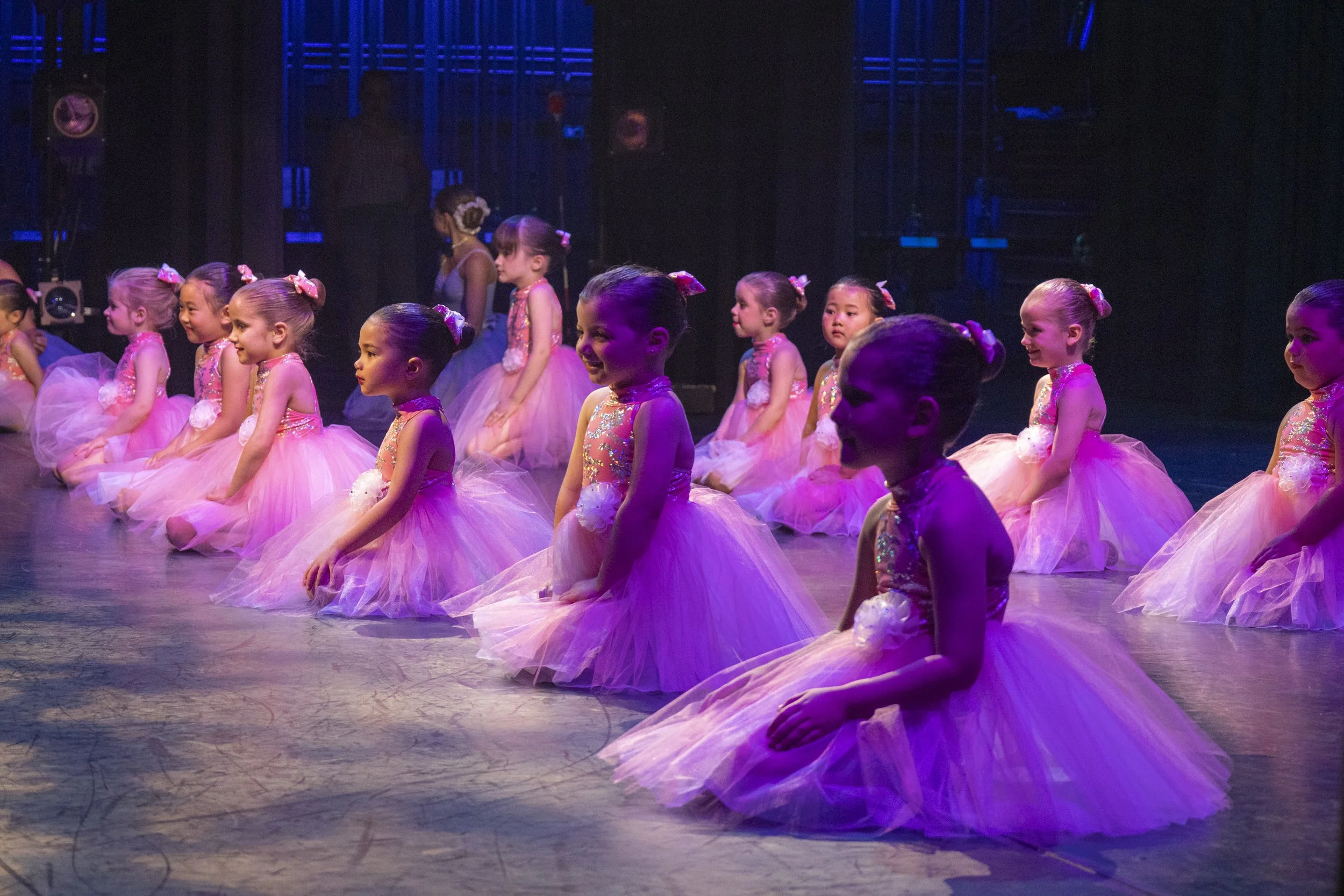 Children in pink tuts on stage at recital