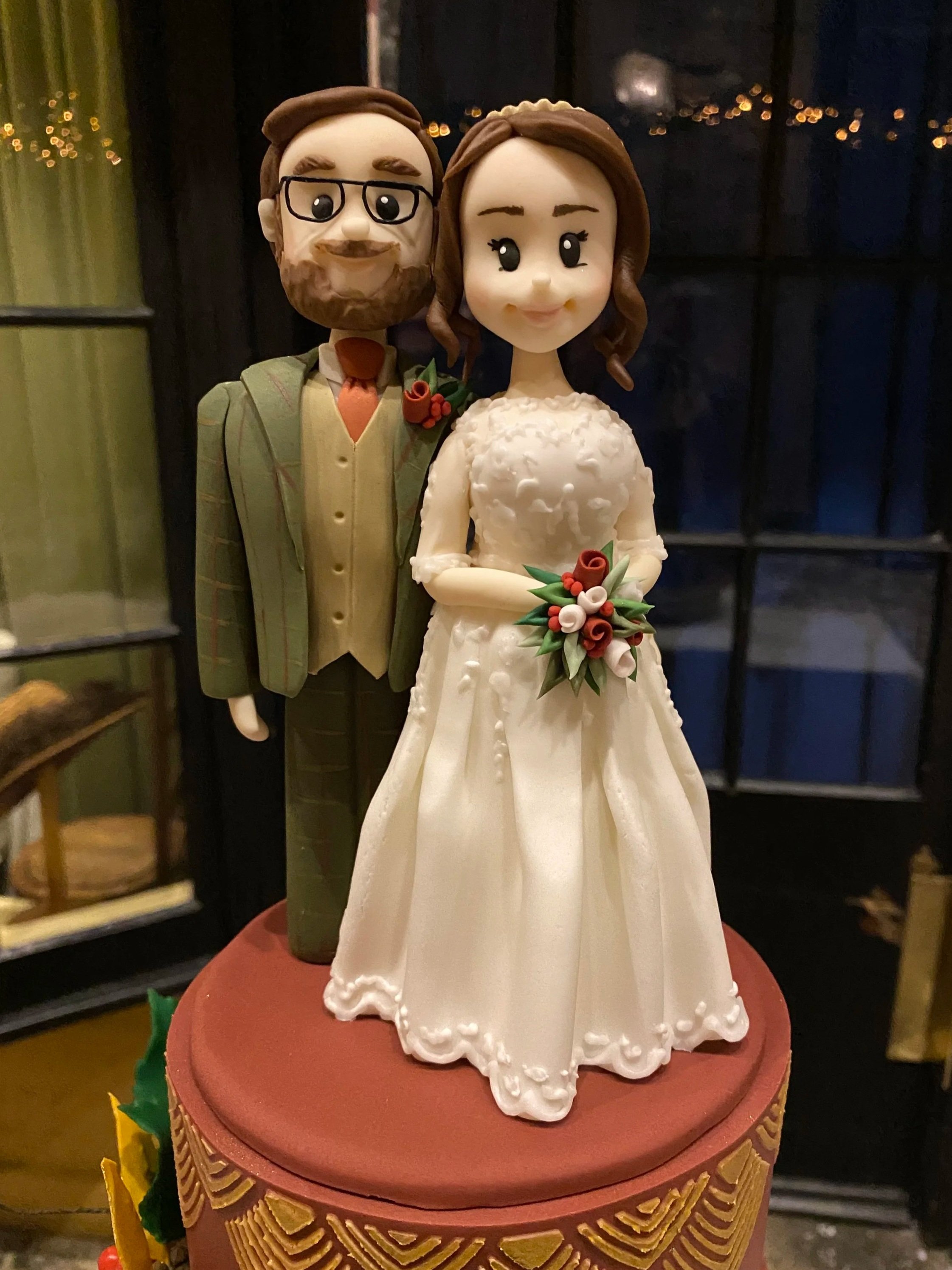 Bride and groom wedding cake topper sat on top of a wedding cake set up at York Castle Museum