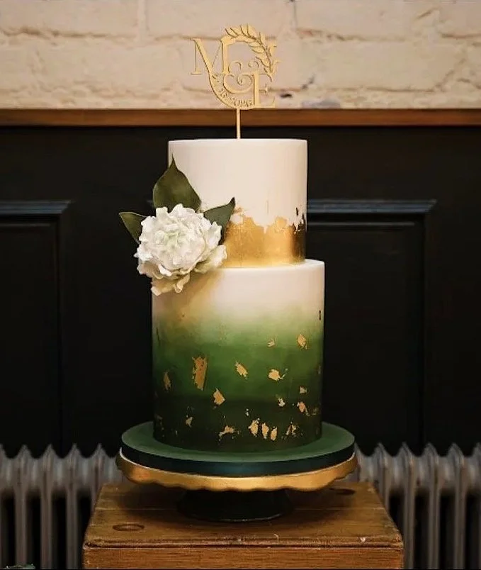 Green ombre two tier wedding cake with gold leaf and flower