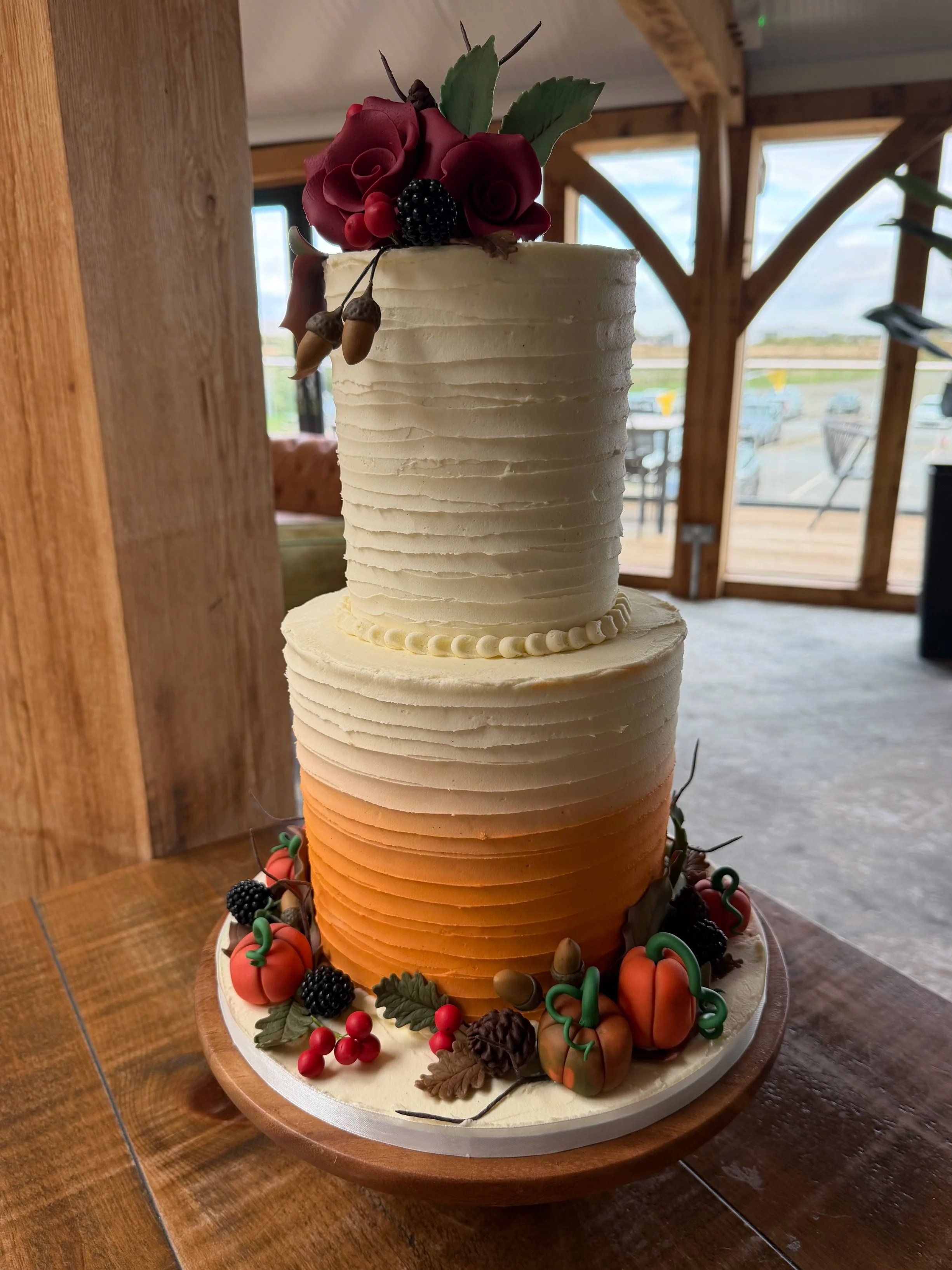 Orange ombre two tier wedding cake with Autumnal decoration
