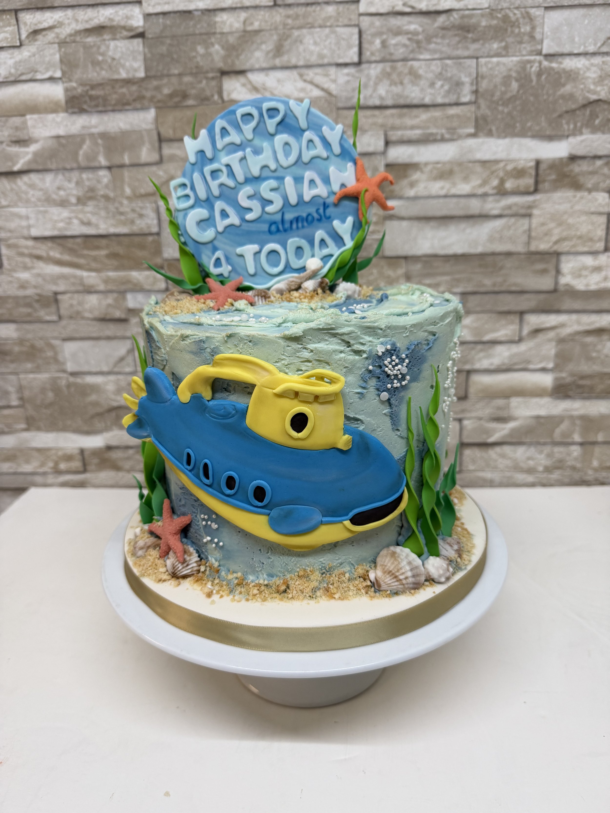 Under the sea theme birthday cake. Buttercream covering with fondant submarine decoration