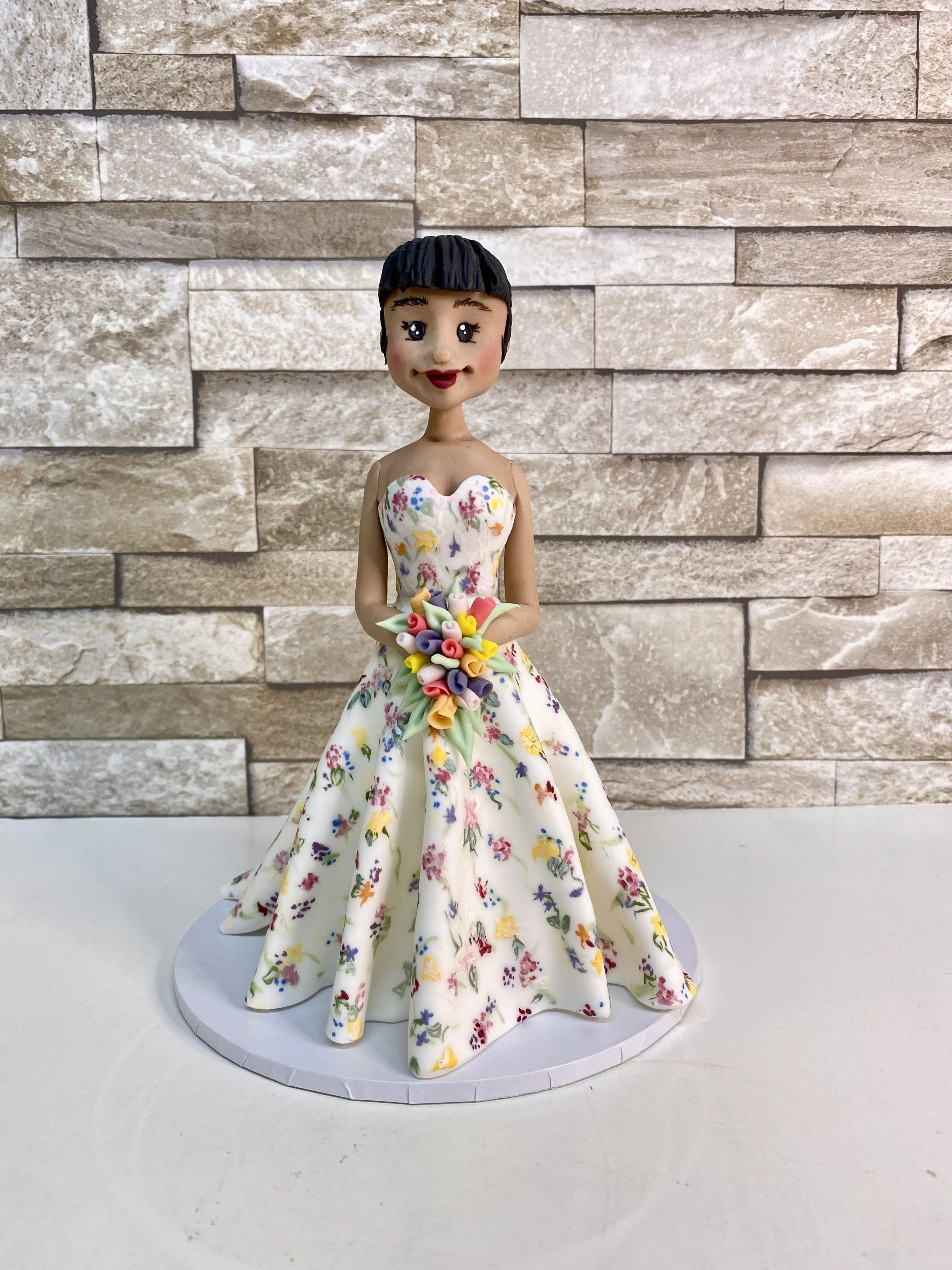 Single bride cake figurine, bride dressed in a House of Savin couture gown with painted flowers