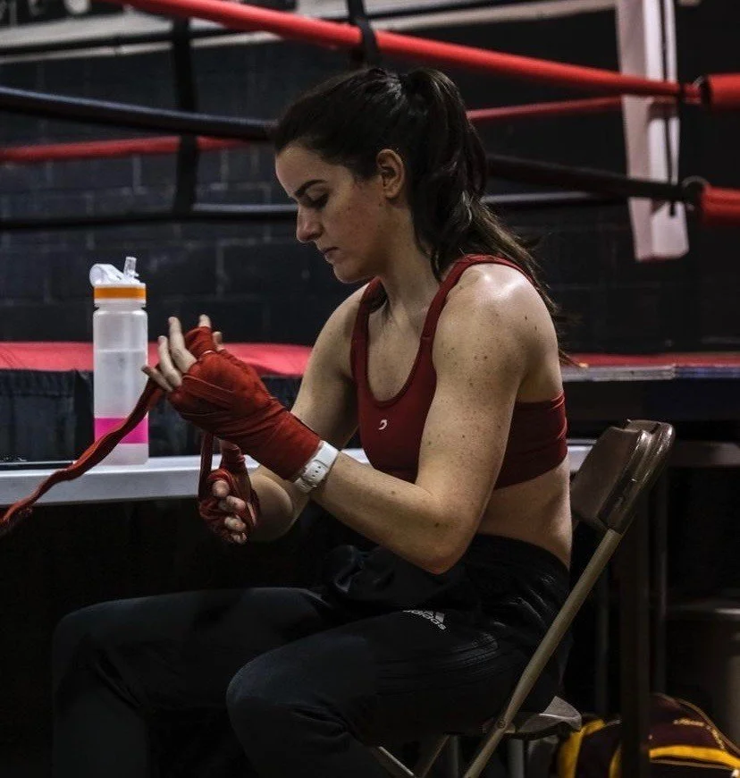 Sunlight illuminating mountain peaks with clouds and forested slopes below.