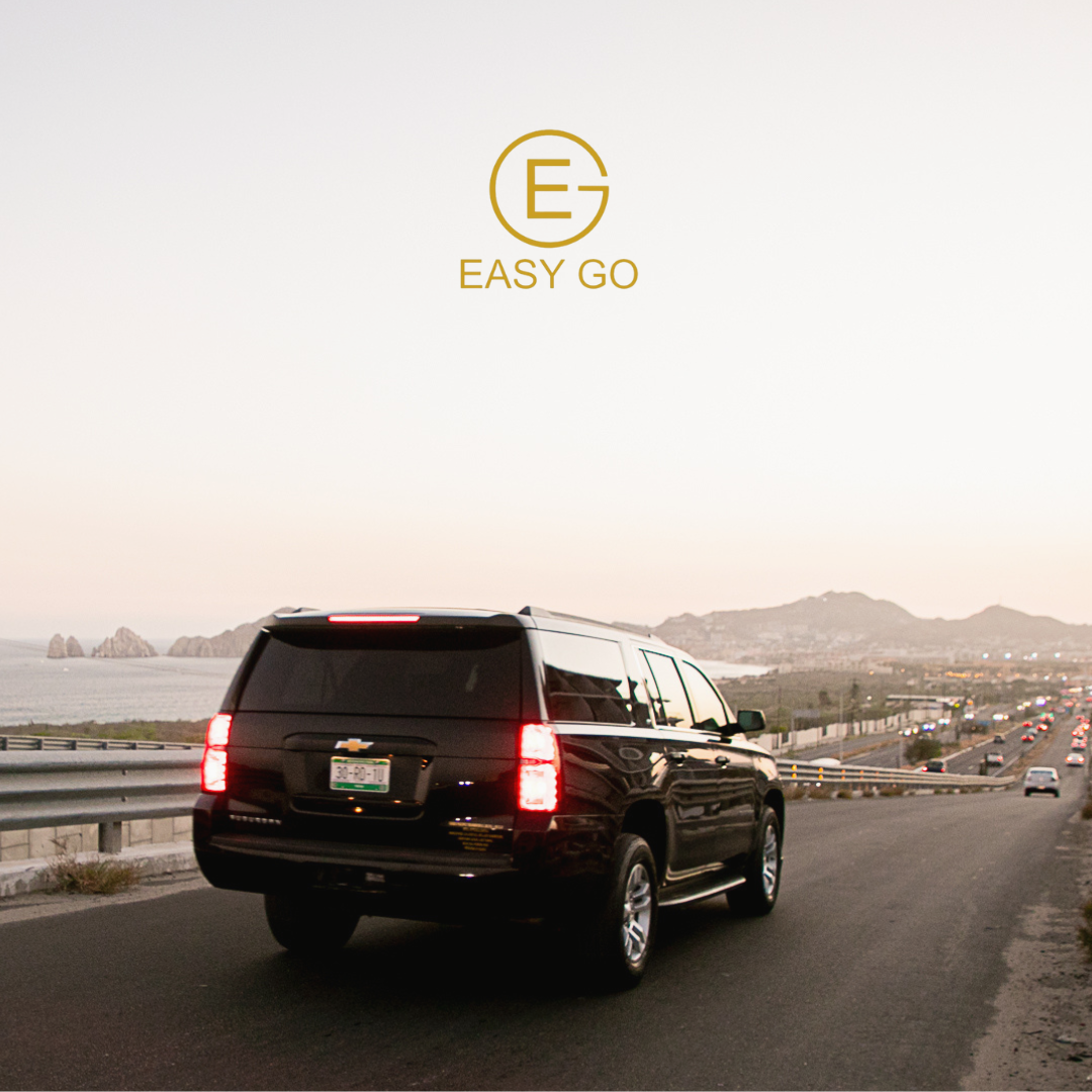 Black Chevrolet SUV driving on a highway near the coast during sunset with mountains and ocean in the background, and the Easy Go logo at the top center.
