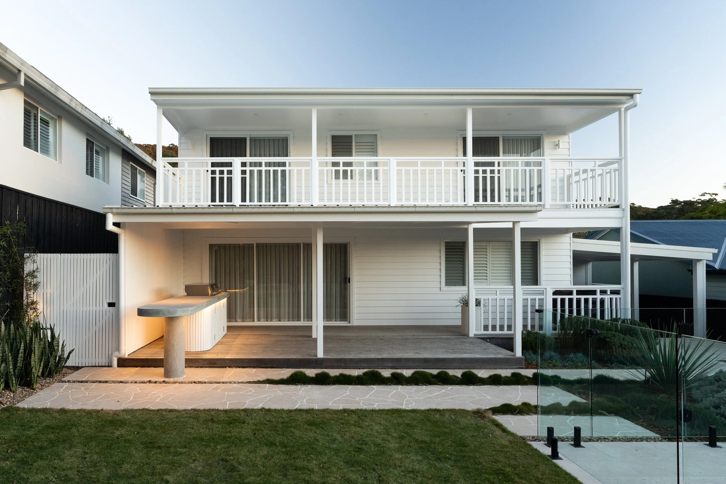 Modern Wamberal home with a custom swimming pool, outdoor cooking area, lawn and integrated landscape design.
