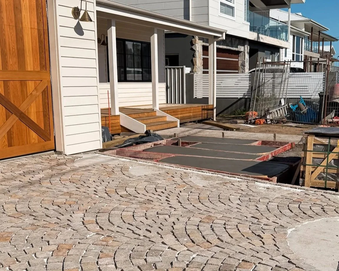 Cobblestone driveway designed and built on the Central Coast, using durable stone paving for a timeless, low-maintenance landscape finish.