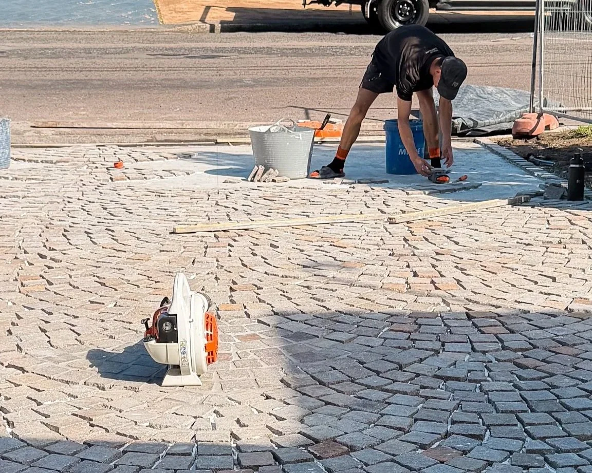Central Coast cobblestone driveway with durable stone paving and a classic landscape design finish.