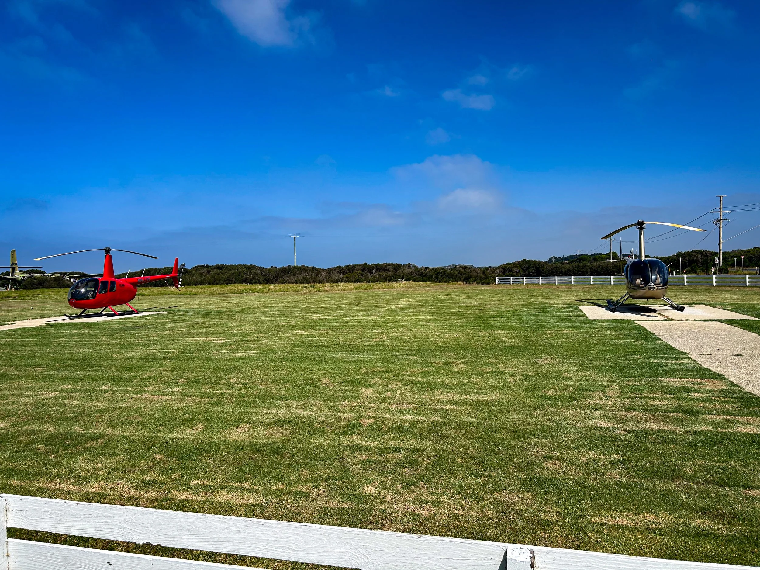 A helicopter flying through a partly cloudy sky during daytime.