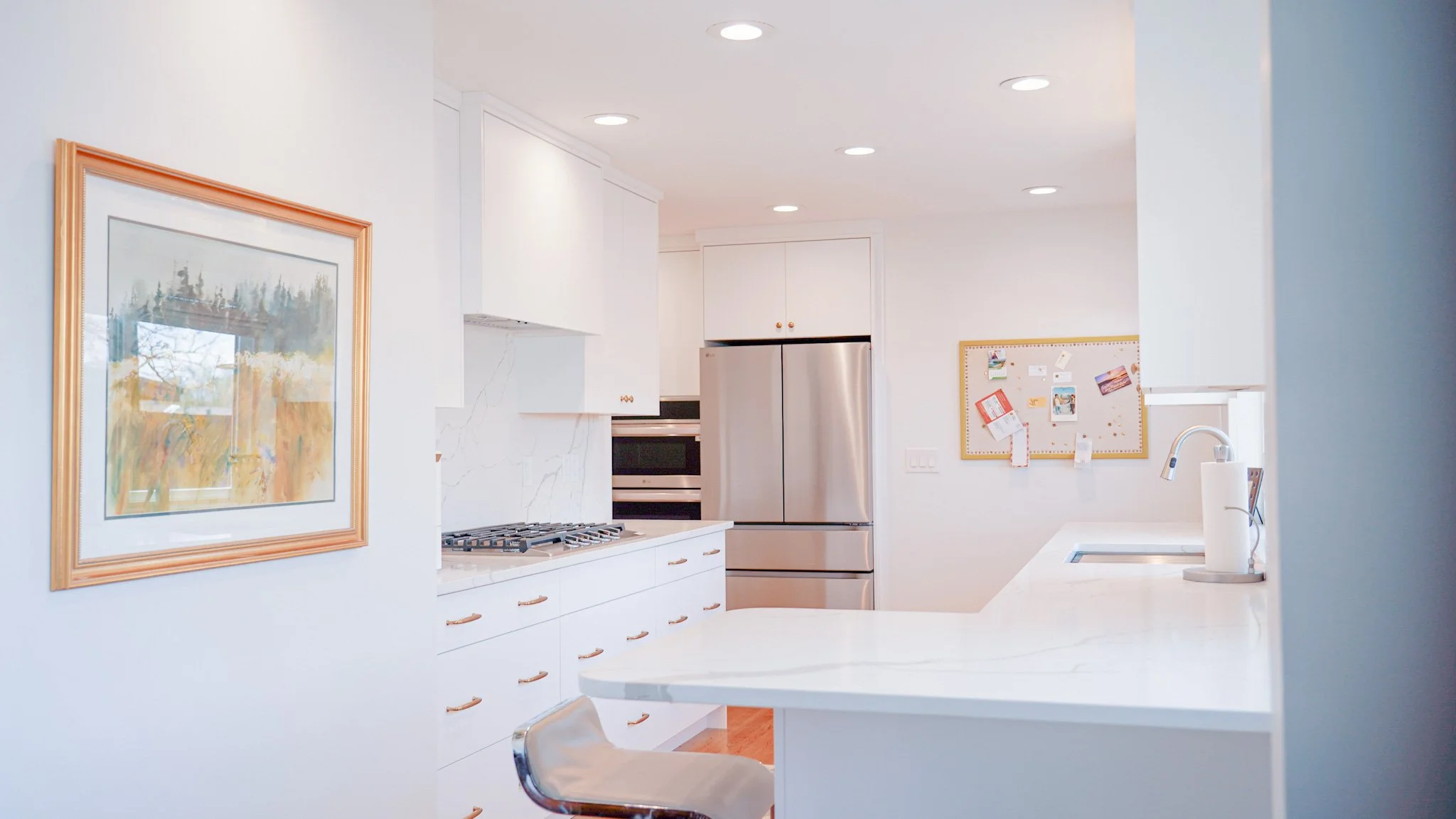 Kitchen island with granite countertops, stainless steel appliances, in-wall stove