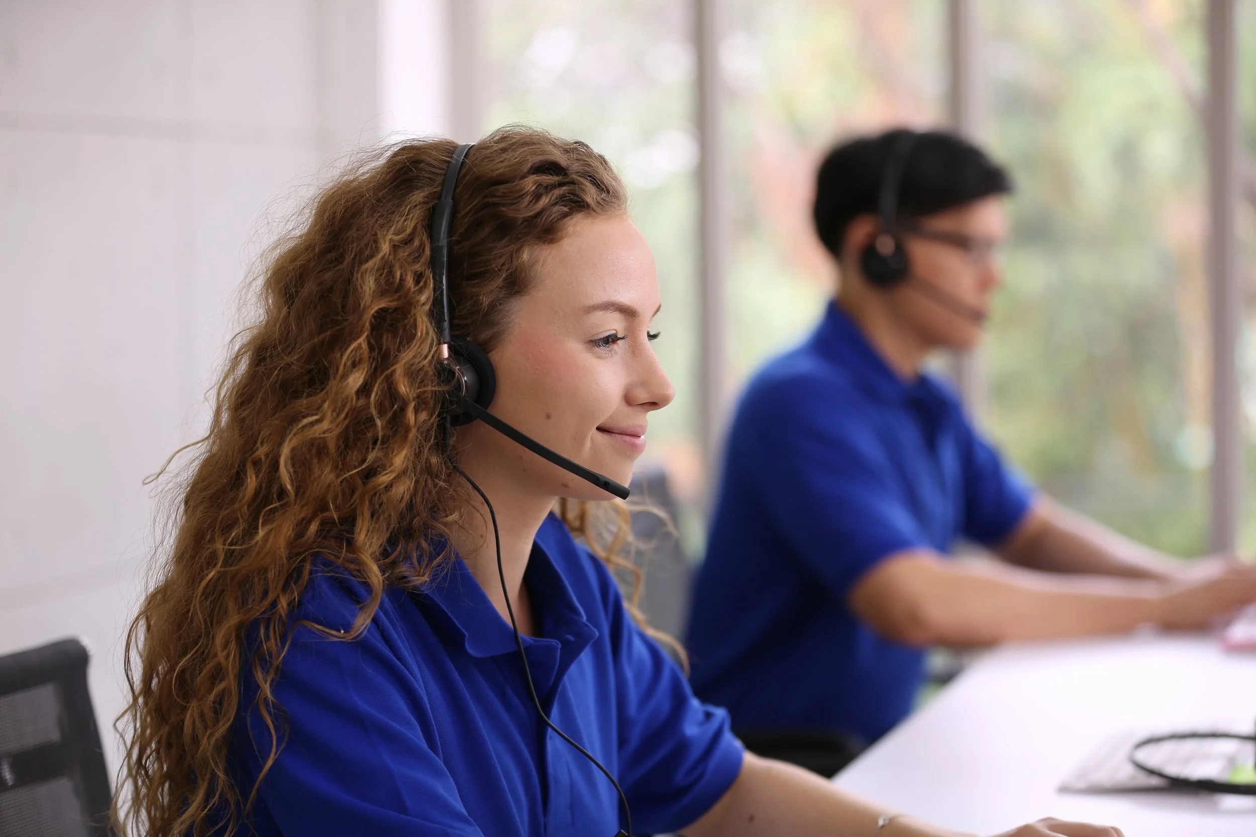 smiling-woman-in-headset-working-in-call-center-of-2023-11-27-05-01-21-utc.JPG