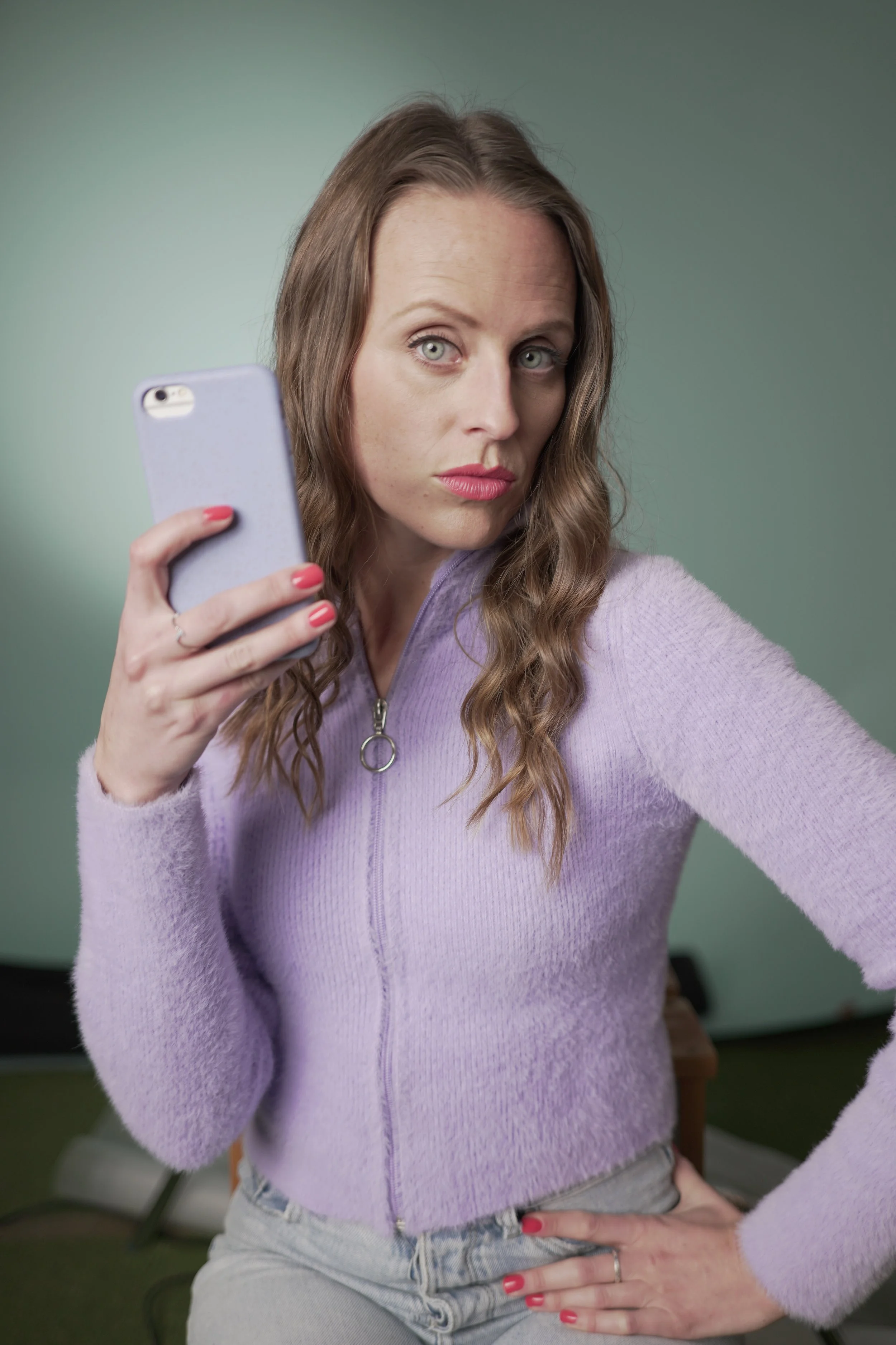 A woman holding a phone in ETC short film What's Up..