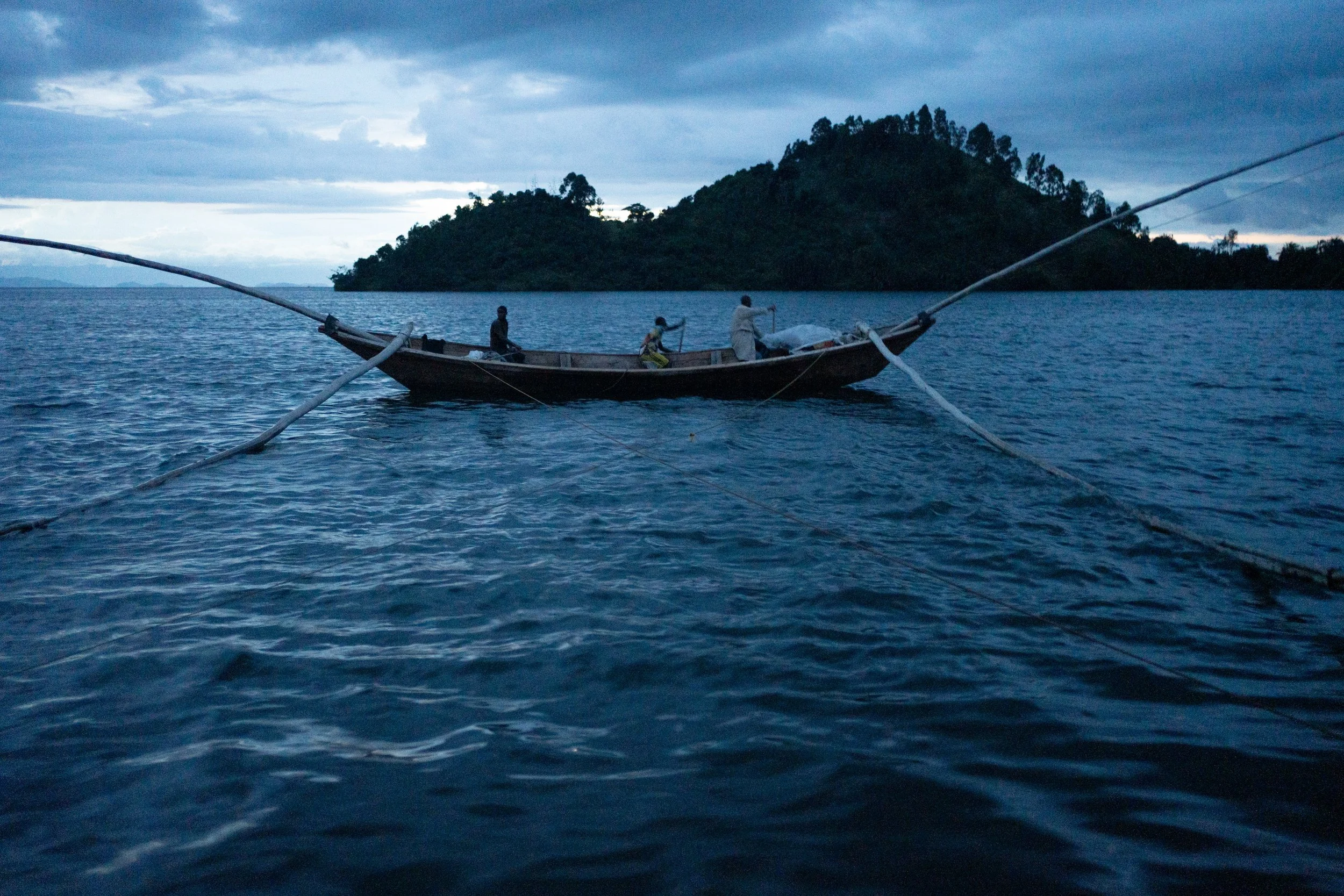 John is the captain of a crew of nine people operating three boats. Every evening, at dusk, they set out on the lake to fish.