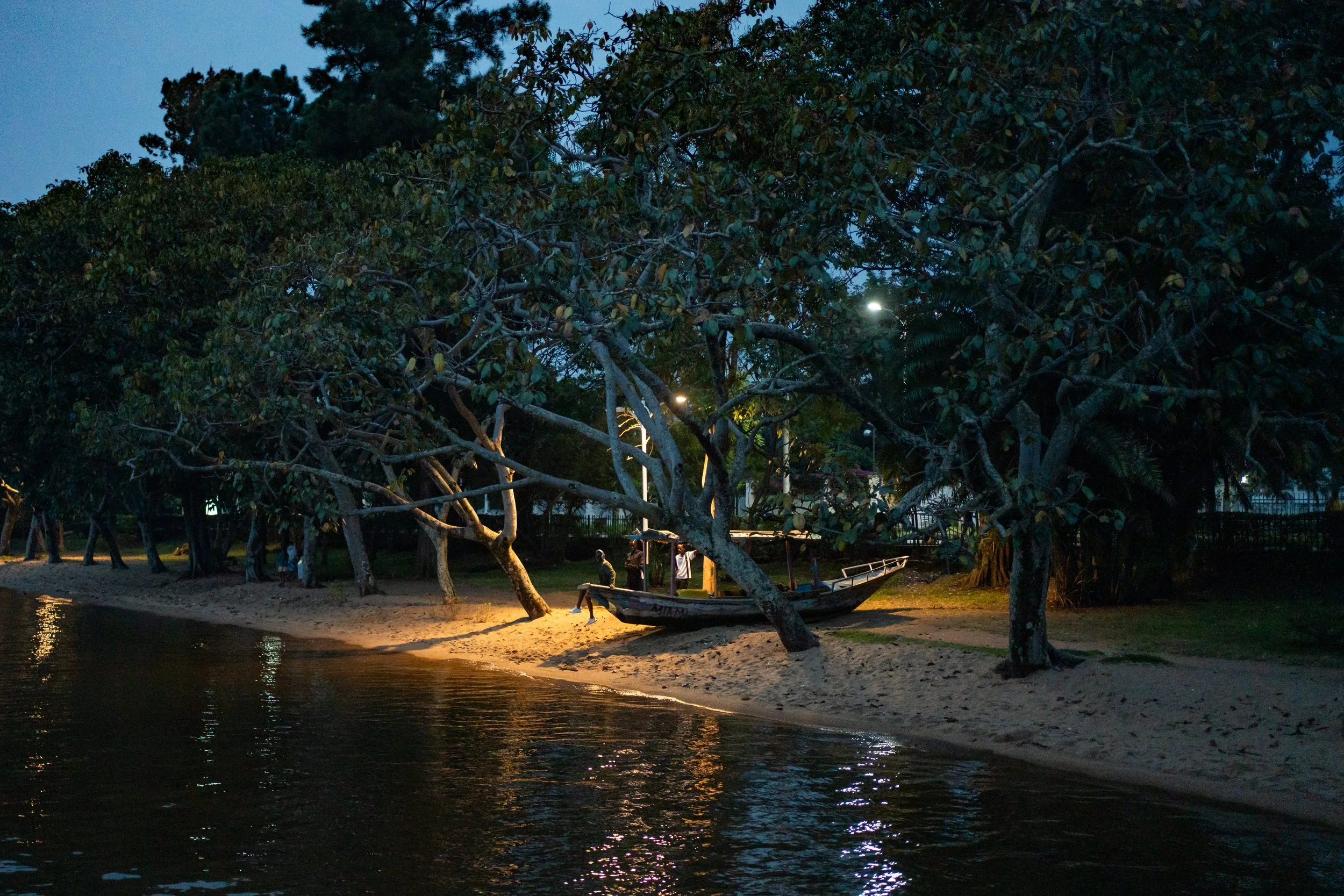 In Gisenyi, a park lit by public lighting borders the lake.