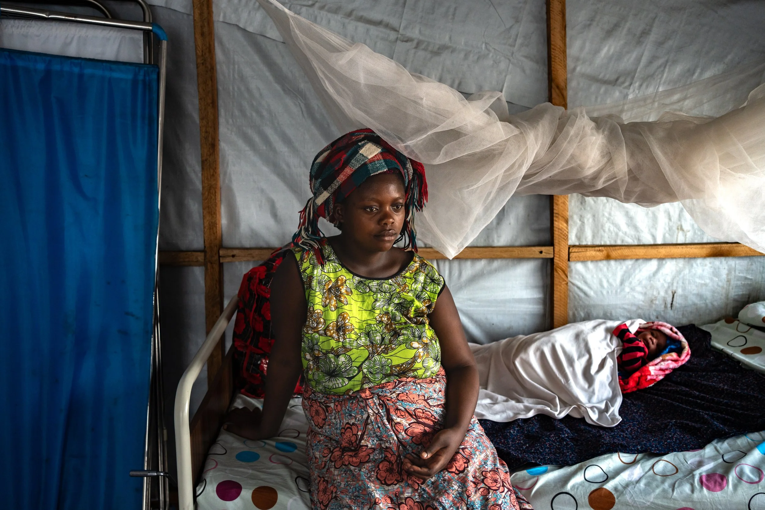 Sifa, 21, is from Sake, which she fled due to the clashes. She has just given birth to a baby boy. She doesn't know where the father is. She named him La Guerre because "it's all I’ve known so far." Goma, February 26, 2025.