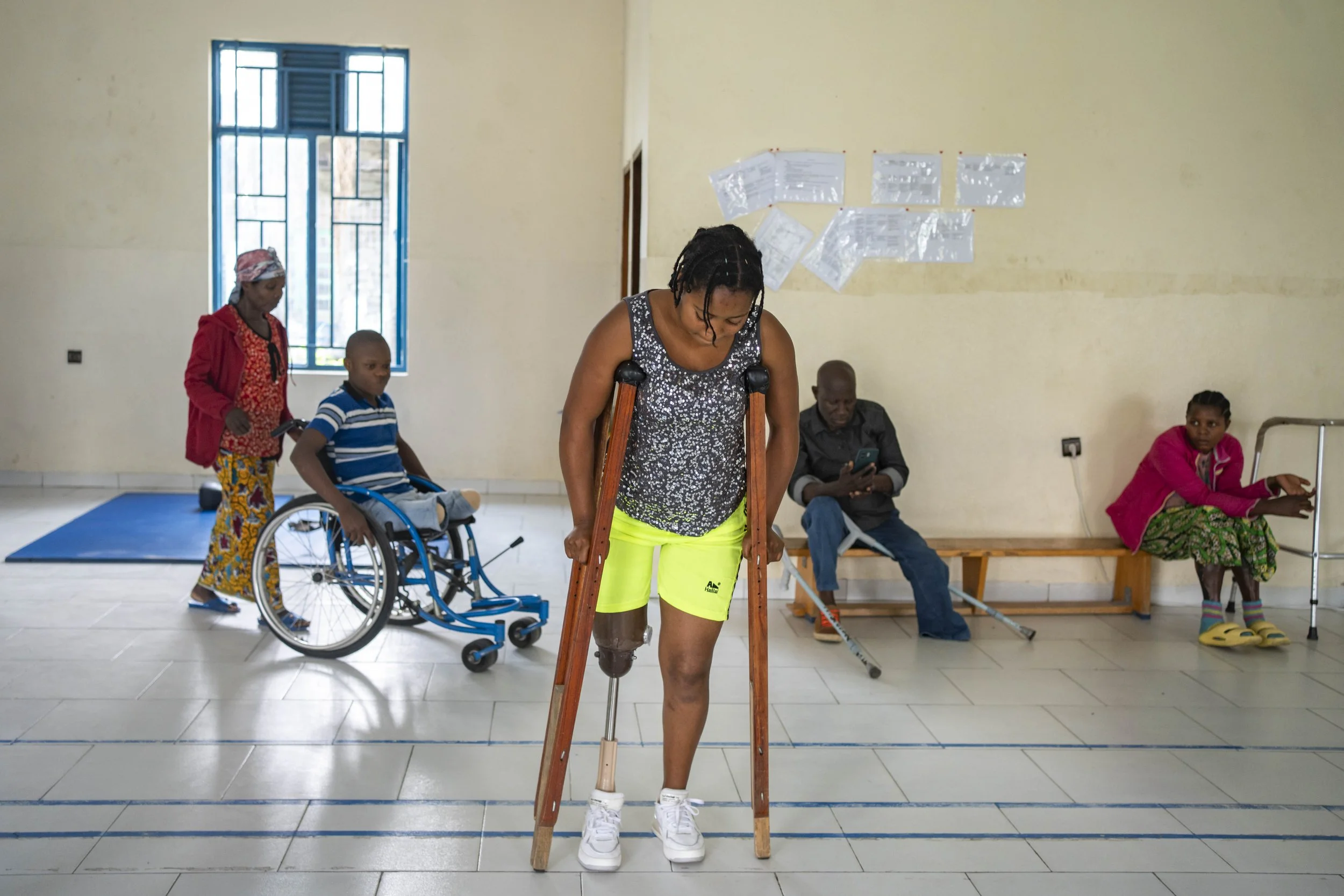 Sarah Twisenge, 18, is taking her first steps with a prosthetic leg.  “We were coming back from church with my two brothers and three friends. We took shelter in a house, but a bomb fell on the roof. I am the only survivor.” Shirika La Umoja Hospital