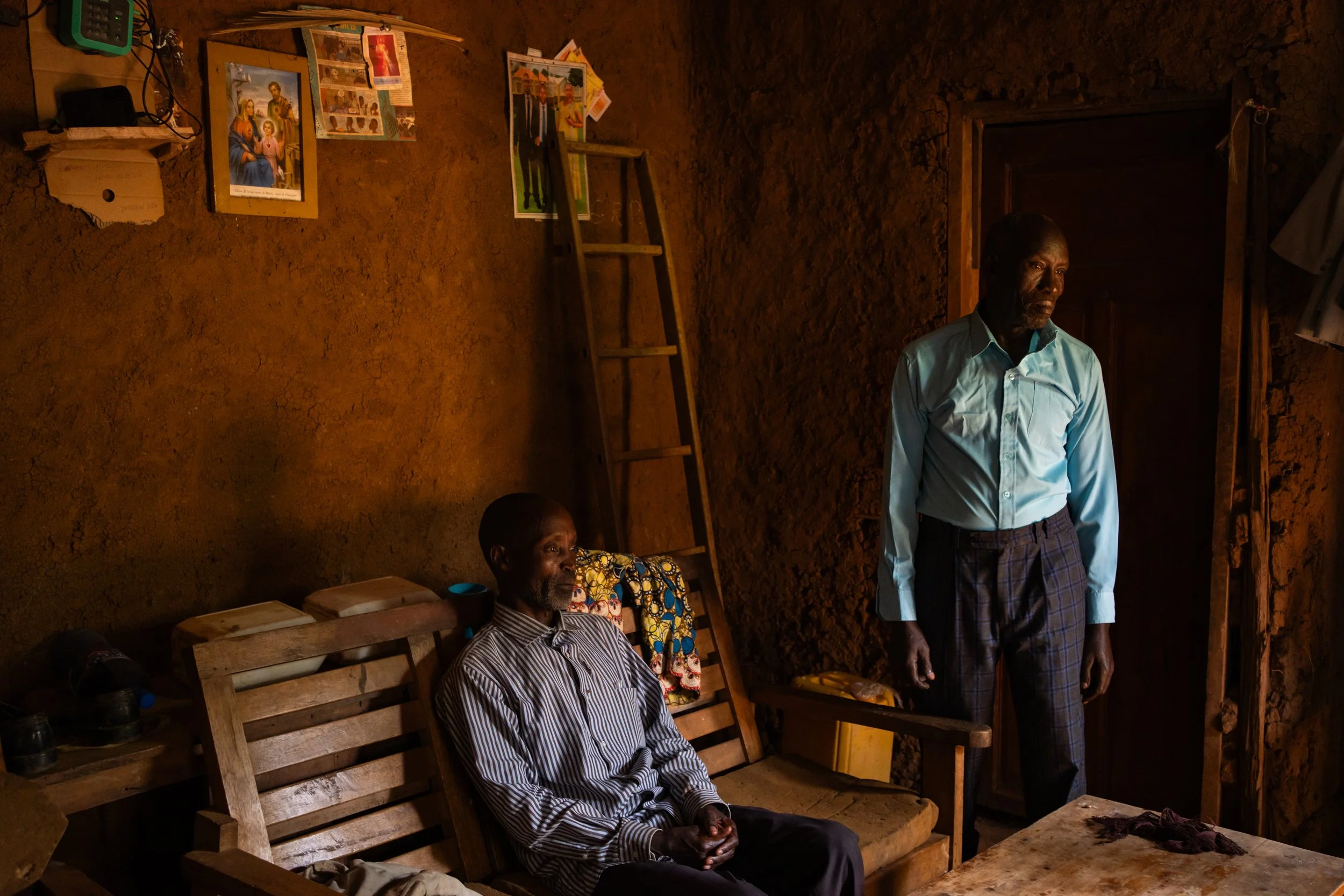“It was my conscience that caught up with me, because we were already living like one family,” says Thadée, 70 (right). Thirty years ago, during the genocide against the Tutsis, Thadée helped Fabien, 58 (left), and his mother cross the lake to reach 