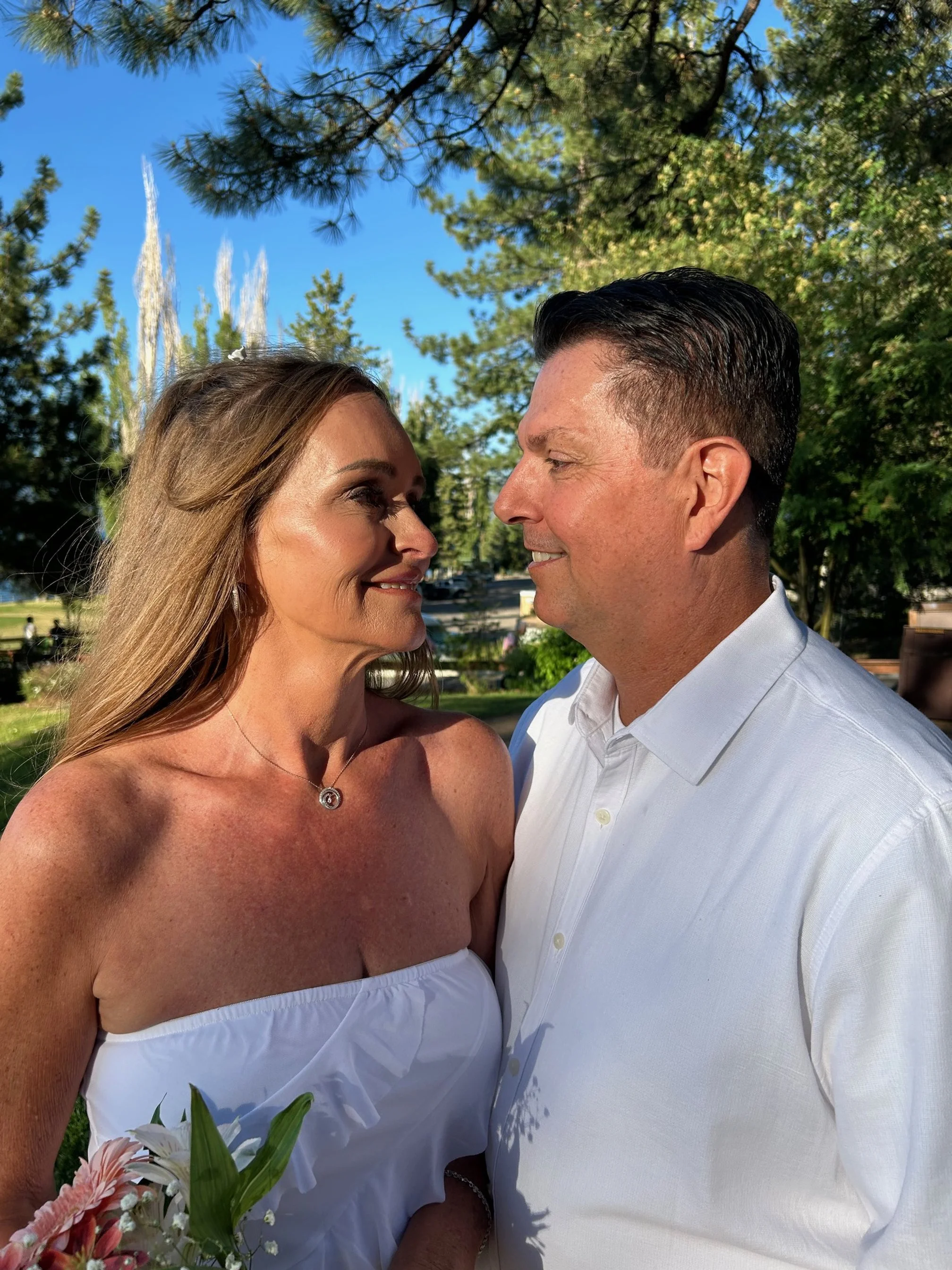 Laurie’s customers, Fernando and Kate embracing by the lake on their wedding day.