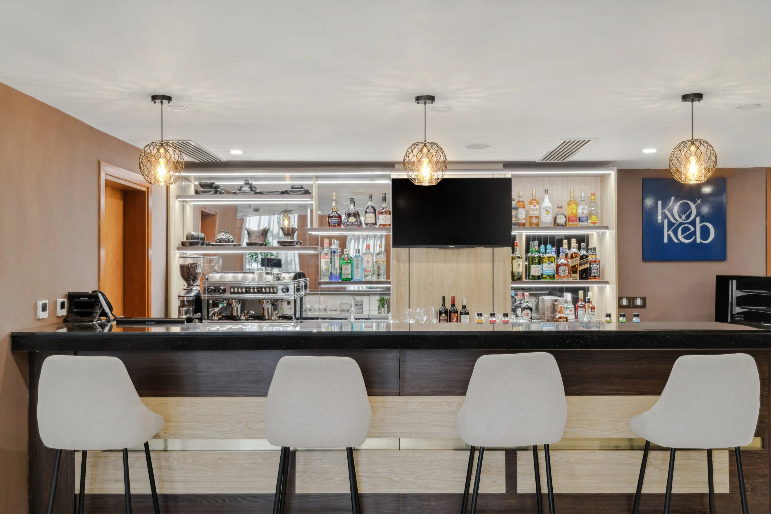 Hotel photography of hilton addis ababa airport in africa by miguel gomes professional hotel and hospitality photographer. photography featuring interior design of the bar from the interior.