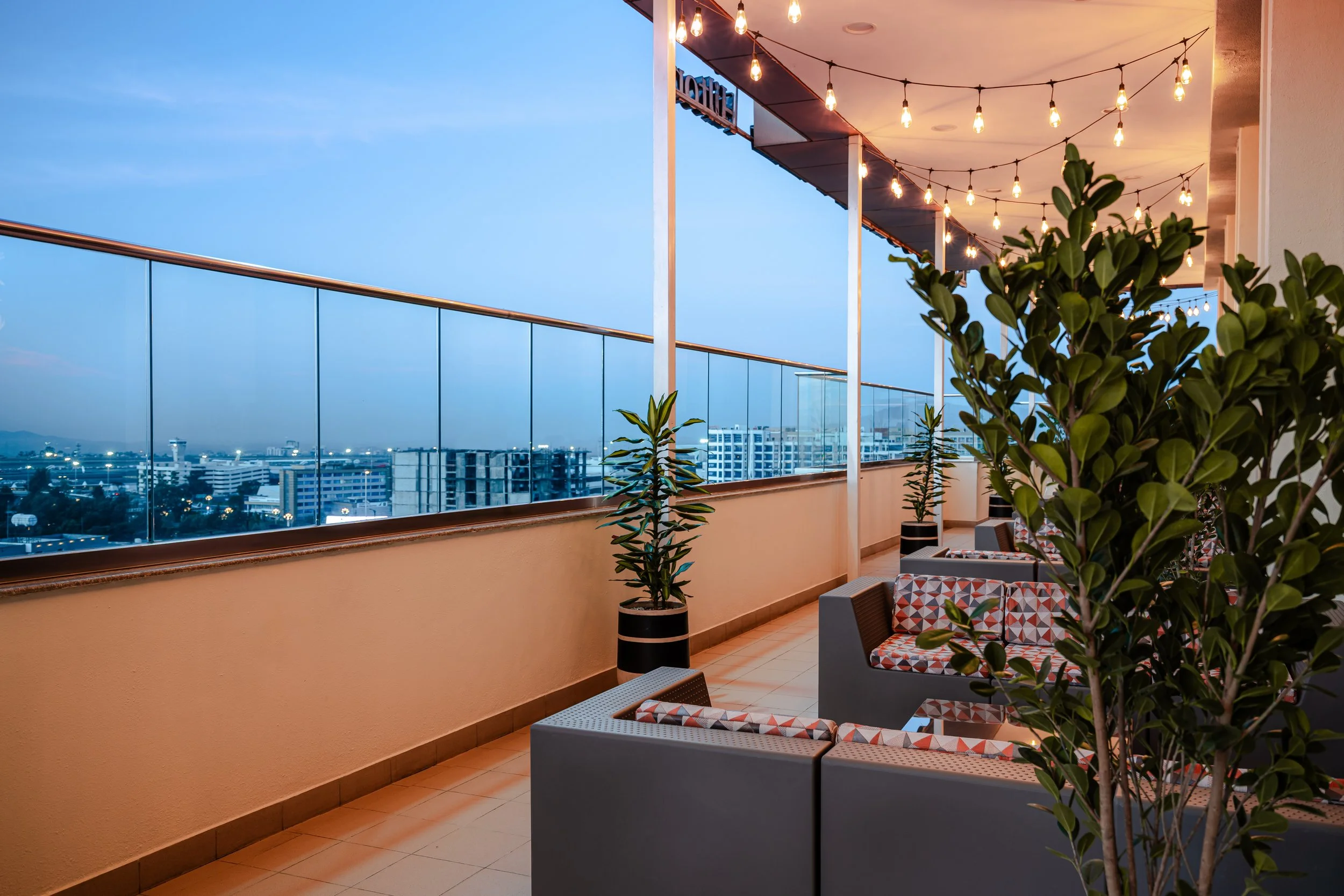 Hotel photography of hilton addis ababa airport in africa by miguel gomes professional hotel and hospitality photographer. photography featuring architecture and interior design of a balcony with view from the interior. Located in Ethiopia, Africa.