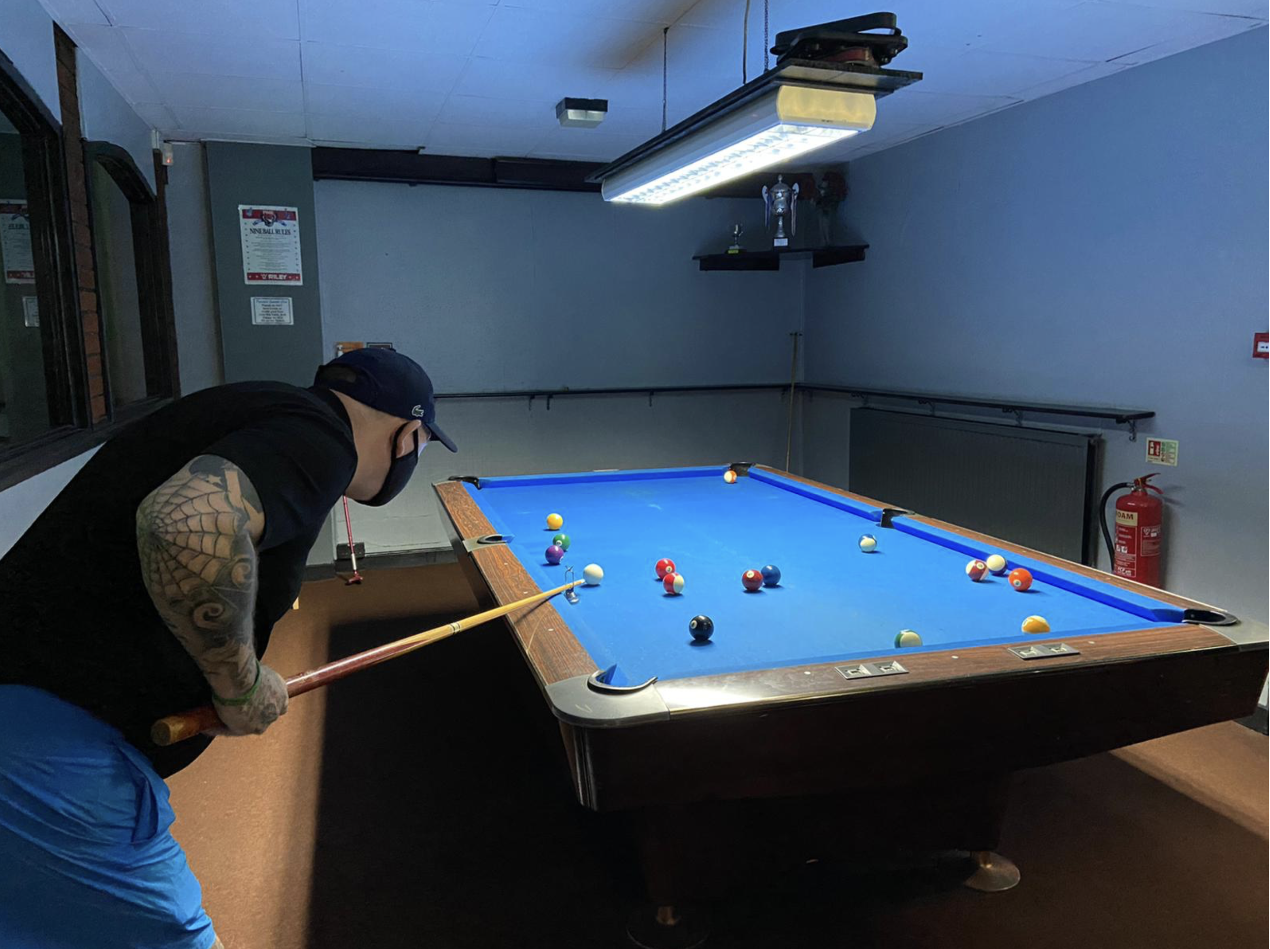 Rehab Assistant helping our client play pool.png